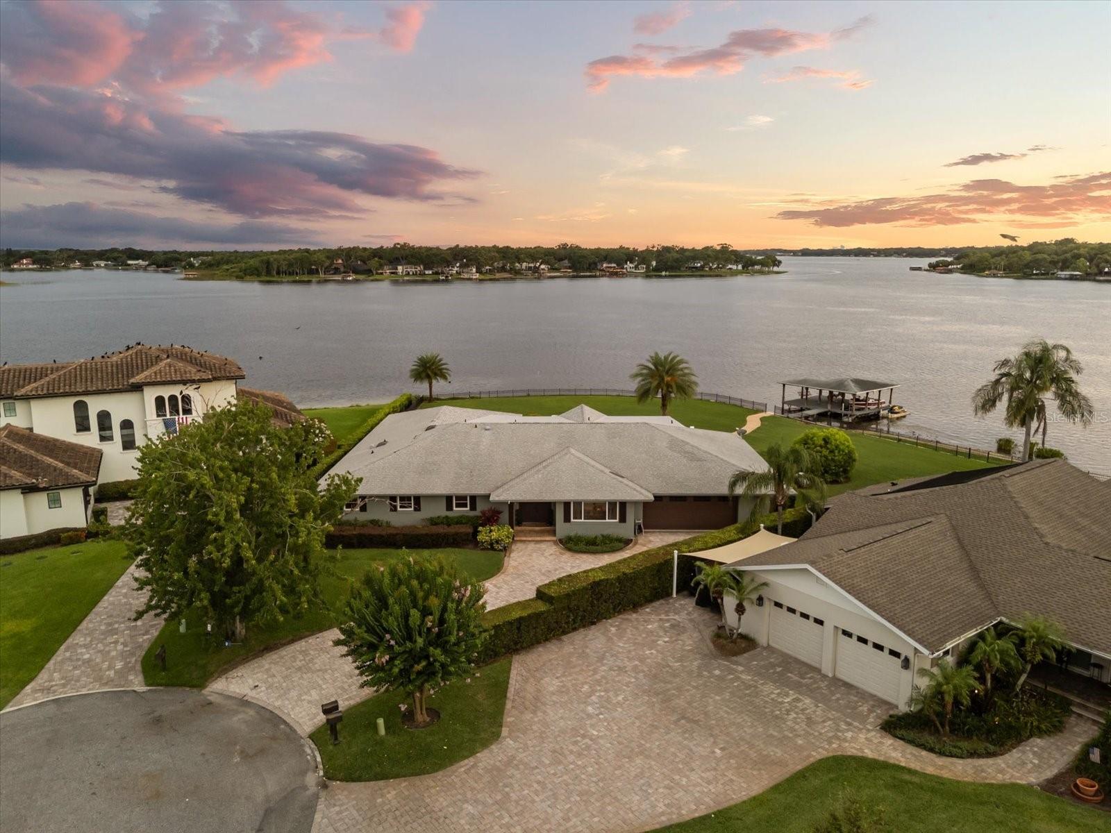 Welcome to the best lot on the Lake Conway Chain of Lakes! Step into your personal paradise in this exquisite lakefront home, perfectly situated at the end of a peaceful cul-de-sac in the scenic Little Lake Conway neighborhood. With 303 feet of enchanting lake frontage on a peninsula, prepare to be charmed by breathtaking sunsets that greet you from the comfort of your backyard.
This impressive 3,552 square foot residence boasts five bedrooms and four bathrooms, designed with a thoughtful semi-split floor plan that defines elegance and functionality. The updated kitchen (2017) flows seamlessly into multiple defined living spaces, inviting culinary creativity and memorable gatherings. Outdoors, your very own kitchen is equipped with multiple flat-screen TVs and a projector, creating an inviting atmosphere for entertaining under the stars, complemented by a cozy fire pit that beckons tranquil evenings by the water.
The outdoor spaces are nothing short of spectacular, featuring picturesque sunset views and a private dock for your boat and jet ski, providing instant access to the stunning Lake Conway Chain of Lakes. Revel in the serene ambiance as you take in nearly 180 degrees of stunning lake vistas, making every day at home feel like a vacation.
This property is ideally positioned for those seeking the perfect blend of lakefront living and convenience. Just minutes away from Downtown Orlando, the bustling Hourglass District, the trendy Delaney Park, and the cultural heart of the city at the Dr. Phillips Performing Arts Center, your new home sits at the crossroads of leisure and lifestyle.
Families will appreciate the top-rated Pershing K-8 and Boone High School zoning, making this residence a wonderful place to nurture both adventure and academic achievement. This home is not simply a place to live; it’s a canvas for your ideal lifestyle, whether you choose to move in as-is, renovate, or clear the lot for your dream home.
Seize the opportunity to own one of the finest lots on the Lake Conway Chain of Lakes—your spectacular lakefront retreat is ready to welcome you home!