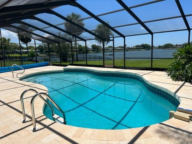 WELCOME TO YOUR RARE WATERFRONT GEM at 9611 Towanda Ln, Port Richey, FL. ENJOY UNMATCHED VIEWS & ULTIMATE PRIVACY with PANORAMIC VIEWS of Lake Christina. Your new home features 2 bedrooms, 2 bathrooms, 1 car garage with nearly 1500 sqft in a no HOA zone. Set on an oversized third of an acre lot on a cul de sac, this POOL home offers an IDEAL blend of comfort, privacy and outdoor living. Step inside to a BRIGHT, OPEN FLOOR PLAN consisting of the foyer with coat closet, living room, dining room, dinette, kitchen & family room. Nearly every room offers BREATHTAKING WATERFRONT VIEWS! Kayak, fish, or birdwatch right from your backyard. The spacious living areas flow seamlessly into the screened and HEATED pool, and out to the expansive pavered lanai and extended pool deck — SUPERB for entertaining, al fresco dining, or simply soaking in the serene natural surroundings. The primary suite offers private lanai access, stunning lake and pool views, a walk-in closet, and a full en-suite bath with double sinks, stone counters & tub/shower combo. All the rooms are dressed with upscale ceramic tiles for easy breezy cleaning. Another AMAZING feature are the DOUBLE-PANE, THERMAL TINTED, LOW E SLIDING GLASS DOORS to the lanai from the family room, dining room & primary bedroom. The ENTIRE home inside has just been professionally painted in a NEUTRAL COLOR (June 2025) & the LUSH landscaping is sculpted beautifully (June 2025). The oversized garage has washer, dryer, utility sink, built-in cabinets & side door access. Rent includes lawn care (mowing lawn & tree/shrub trimming), irrigation from lake (so lower water bill) & pool maintenance. Pets are welcome. CRUISE to downtown New Port Richey featuring FANTASTIC restaurants, taverns, festivals, shopping & professional offices. Sims Park is PHENOMENAL for everyone with a playground, splash pad, walking paths along the river & an outdoor amphitheater. The public boat launch is a few short distance away where you can take your boat directly to the Gulf of Mexico or enjoy kayaking down the river. The City of New Port Richey is BUSTLING & THRIVING! Location is PERFECT near schools, beaches, medical plazas, shopping centers, restaurants, places of worship, airport & tourist attractions. MAKE THIS YOUR FUTURE HOME!