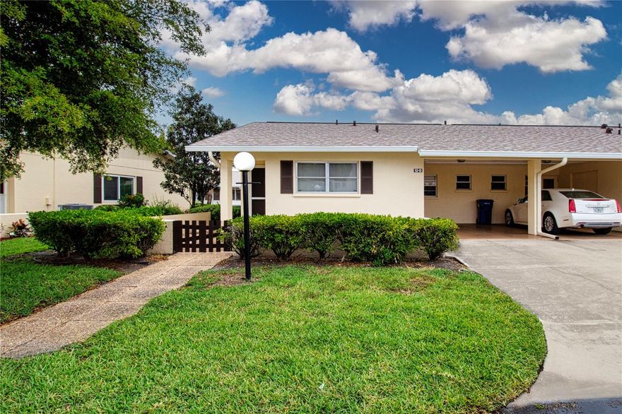 Welcome to easy, maintenance-free living in this beautifully maintained 2-bedroom, 2-bath turnkey villa, thoughtfully designed for comfort and convenience. Featuring a nicely appointed floor plan, this home offers a bright and inviting living space ideal for both relaxing and entertaining—just bring your suitcase and move right in. Additional highlights include a covered carport for convenient parking, a dedicated laundry closet, and valuable attic storage for extra space. Enjoy both front and rear outdoor patio areas—perfect for morning coffee, evening relaxation, or entertaining guests. Located in the gated 55+ community of DeSoto Square Villas, this residence is ideally located directly across from the clubhouse,  pool and tennis courts, putting resort-style amenities just steps from your door. Enjoy year-round relaxation in the geothermal heated pool, gather with neighbors at the clubhouse, or stay active with billiards, fitness activities, pickleball, tennis, and shuffleboard. This desirable community offers an affordable lifestyle without compromising on amenities or location. Conveniently situated near medical facilities, places of worship, dining, shopping, public transportation, and just a short drive to several beautiful Gulf Coast beaches. Experience the perfect blend of comfort, convenience, and active living—your ideal Florida retreat awaits.