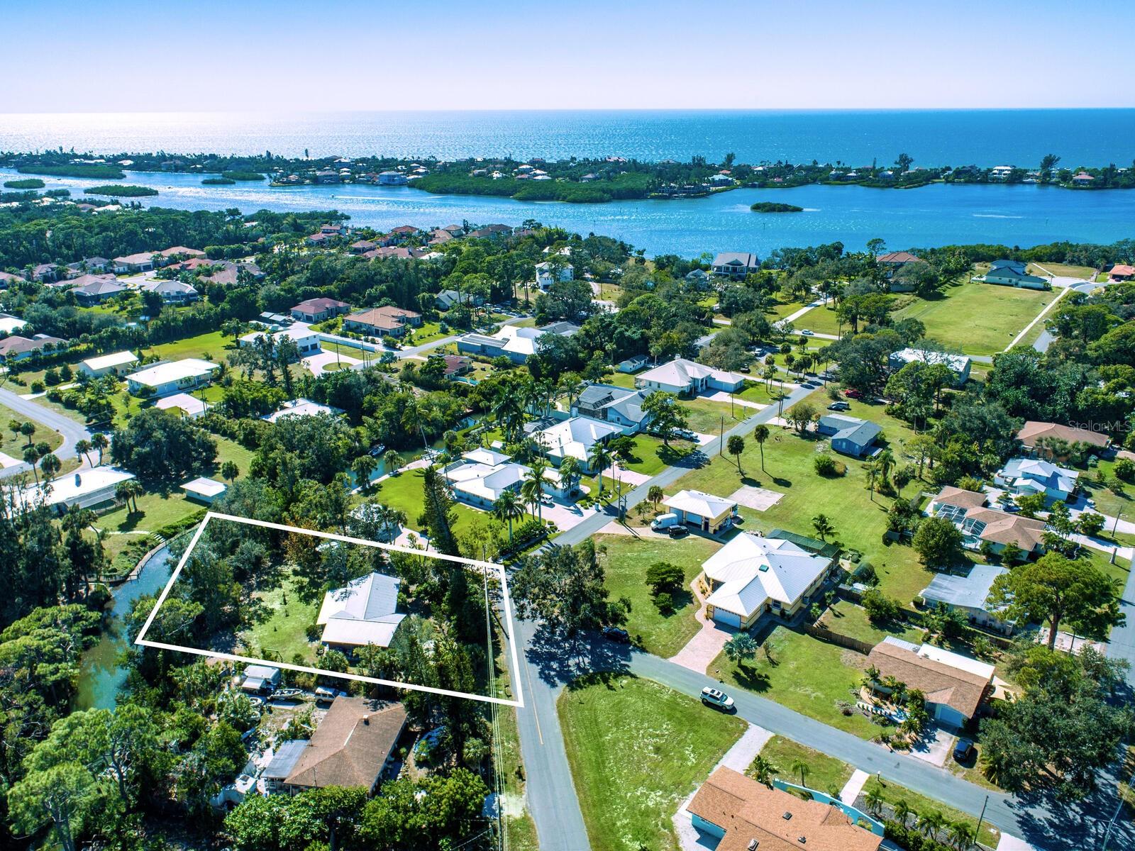 Waterfront home 6 homesites from Blackburn Bay and the IntraCoastal Waterway with access to the Gulf of Mexico! This property features 172 feet of canal frontage with a boat dock with water and electricity. Property is just under an half acre. There is plenty of room to install a pool of any size. This cottage style home is inviting as it is, although you may want to expand it or start over and design and build your own waterfront dream house! This home currently features 2 bedrooms, 2 baths and a 31 ft long lanai/porch along with an oversized garage that you may wish to use to store your boat along with your cars. It also has an open floorplan with the dining room/living room off the kitchen. Both the home and the shed feature a long-lasting metal roof with cedar siding. This property is located near all that the local area has to offer along with easy access to Sarasota and its restaurants, shopping, and the arts. Come visit this generous waterfront property!