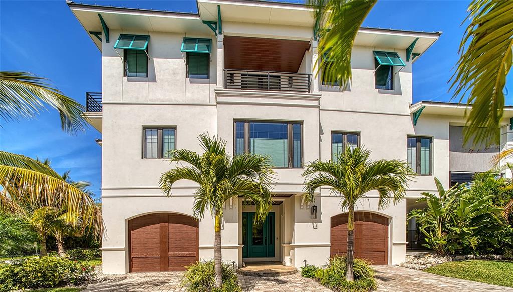 This former model is a luxurious coastal contemporary home located at The Preserve of Longbeach. The home is infused with light and flows seamlessly from the indoor to the outdoor space. The main living area has a very open feel from the kitchen to the dining area to the living room which features a warm inviting fireplace and an adjacent enclosed screened porch with the option of raising screens to create an open porch. The private master suite is located on the first living level with two other en suite bedrooms upstairs. The first level also has a bonus room that could be an office / den. Beautiful engineered wood floors run throughout both levels of the home. The kitchen has all stainless steel Viking appliances. There is a fully landscaped pool area that has a stairway from the first living area plus a three car garage. Refinement meets relaxation at the north end of LBK in Longbeach Village - with beach-to-bay access plus waterfront amenities, al fresco dining, multiple kayak launch points, a neighborhood boat dock and ramp. And an active free-spirited lifestyle await. Exhale and enjoy a neighborhood where peacocks walk the streets, the waterfront is at your fingertips, and all that makes Coastal Florida living so enchanting is yours to enjoy. Be one of only 12.