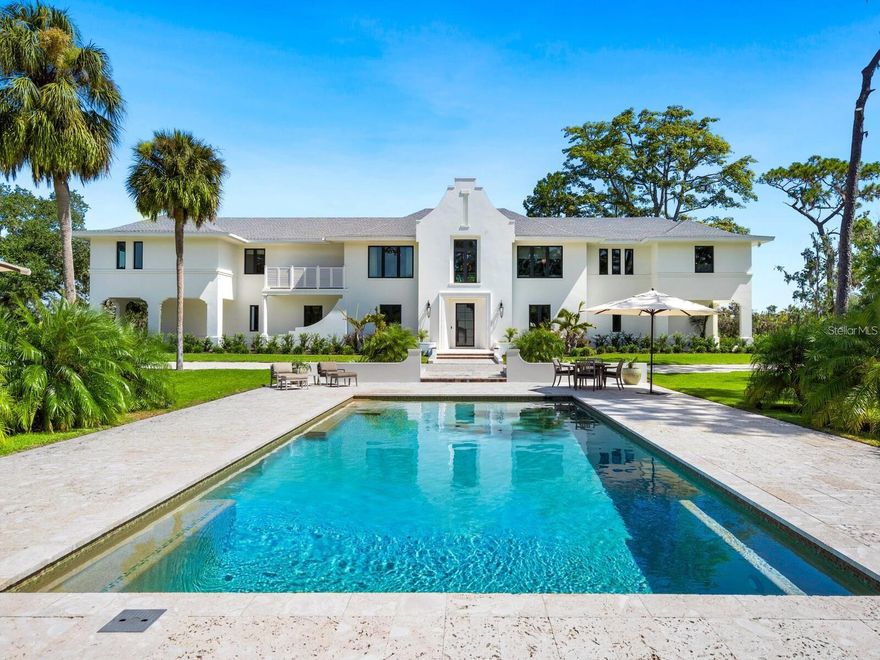 This stunning 30 acre estate is truly one of the most unique and secluded compounds to ever grace the Sarasota/Manatee real estate market. Nestled along the banks of the tranquil Manatee River, this spectacular Cape Dutch inspired home was built in 2021 with absolutely no detail or expense spared. Every room in this elegant yet understated 4,489 sq. ft. home is designed to capitalize on the spectacular views - the meandering river with a huge preserve beyond, majestic moss draped oaks, the exquisite pool and koi pond, and the simple beauty of Florida nature as far as the eye can see. The immaculate interior of the home centers around a large open living area that flows into two thoughtfully designed separate wings, allowing space and privacy. The home was purposefully designed around the topography of the land and the natural habitat to capitalize on the abundance of natural light and captivating views. The owners chose natural interior and exterior finishes such as coral stone, quartzite and acacia wood to mirror the inherent elegant simplicity of the setting. The east wing of the house comprises a library, a gallery, a spacious bedroom suite and a large study/3rd bedroom. The west wing has another large bedroom suite, a study, and a sizable utility/hobby room. Each wing has a staircase to its own garage. The architect provided a revised floor plan for additional bedrooms if needed. Between the garages on the first floor sit two large, air-conditioned spaces used as a gym and a hobby room which open onto a covered terrace overlooking the banks of the river. The estate has a separate 1,265 sf elevated modern guest house. Built in 2020, “The Treehouse” is a light-filled 1 bed, 1.5 bath living space with huge windows overlooking a serene pond. The first floor provides an additional living/sleeping area with an elevator that takes you to the main floor. The large, screened deck is perfect for outdoor grilling and dining. Wildlife plays a huge role in everyday life on the estate; it is a haven for deer, bobcat, owls, otters, turtles, eagles and countless waterbirds. Nesting boxes are hung in trees to encourage and protect the birds. There is a 60 ft dock for boating and fishing; the waterways are home to tarpon, blue crab, redfish, black drum and snook, and you will often see dolphin and manatee cruising past. Among the many uses for the 60’ x 30’ air-conditioned insulated utility barn on site, with an office and full bathroom, are as exotic car storage, boat or RV storage, a woodworking shop or converted into a pickleball or basketball court. Additional structures include a greenhouse with full nursery rack system and a horticultural shade structure, as well as a fabulous “Fish Shack” - a riverfront screened hut for casual sunset gatherings. The property has many trails leading to different areas of the estate including the stone deck at “Sunset Point” which is one of the best places to catch the sunset in winter, and the picnic table at “Pineapple Point” for al fresco dining. Begin your day with a stroll or jog on the Peninsula track around the lagoon and riverfront. The property has a beautiful wetland island. Agricultural zoning allows plenty of space to keep horses or other animals, build tennis courts or install a helipad. Please see attachments for more details on this fabulous Florida estate.
