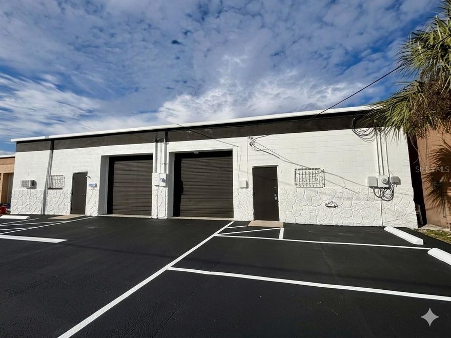 Investment/Owner-User Warehouse With One Unit Leased

Premier two-unit industrial/warehouse property in central St. Petersburg offering immediate cash flow plus upside for an owner-user or investor. The concrete block building totals approximately 5,796 square feet, configured as two roughly –2,880 SF bays, and is situated on a 0.21–0.22 acre GC-zoned lot with easy access to I-275 and major St. Pete corridors.

One unit is currently leased at 2,880 SF on a triple-net (NNN) basis at 2,900 per month plus reimbursement of taxes, insurance, and maintenance, providing stable income with limited landlord expense exposure. The second ±2,900 SF unit is recently renovated and available for lease or for an owner-occupant who wants to operate their business on-site while benefiting from existing rental revenue.

Each bay features an office area with a dedicated window A/C unit, renovated restroom with slop sink, front and rear entry doors, and an oversized roll-up commercial garage door for efficient loading and circulation. The warehouse is constructed of reinforced concrete block with steel rafters and benefits from a newer roof and 200-amp electric service, making it suitable for a wide range of light industrial, service, storage, or small business uses. On-site parking accommodates approximately 6–8 vehicles, and 24-hour access plus available building signage provide excellent functionality and visibility for tenants.

Recent renovations include updated interiors, fresh paint, improved office finishes, and clean “move-in ready” warehouse space, reducing near-term capital needs for a new owner. With flexible suite sizes, NNN lease structure, and strong St. Petersburg industrial demand, this property is an attractive opportunity for investors seeking dependable income or business owners looking to control their facility in a tight market.
Quick property facts (for your marketing remarks)

    Address: 4055–4059 7th Terrace S, St. Petersburg, FL 33711

    Use: Industrial / warehouse with office

    Building size: ±5,760 SF, two bays of ±2,800–2,880 SF each

    Lot size: ±0.21–0.22 acres

    Zoning: GC – General Commercial (check local code for exact permitted uses)

    Construction: Reinforced concrete block with steel rafters; newer roof

    Power: Approx. 200-amp electric service

    Access: Central St. Pete location with convenient access to I-275; 24-hour access

    Parking: Approx. 6–8 surface spaces

    Current income: One ±2,800 SF unit leased at 2,800/month NNN (tenant pays taxes, insurance, and maintenance)

    Availability: One ±2,900 SF renovated unit available for lease or owner-user