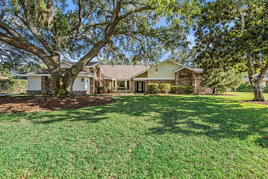 Tucked behind the gates of Cypress Run, this custom estate blends timeless craftsmanship, modern updates, and exceptional Florida outdoor living on a private homesite with sweeping golf course, pond, and preserve views. Set on just under 3/4 acre, this remodeled 4-bedroom, 3.5-bath pool home with side-load 3-car garage features a NEW ROOF in 2022 and a private backyard with no rear homes in sight. Oversized paver driveway (2yrs old) leads to the brick-accented façade, shaded by majestic oaks & lush landscaping. Double entry doors open to a soaring foyer with freshly polished travertine tile, high ceilings, and abundant natural light. The formal dining room features a window seat, while the formal living room offers polished stone flooring, arched transom windows, dramatic ceilings, and French doors to the pool and lanai. The office/4th bedroom includes custom built-in shelving, cabinetry, & desk space, making it ideal for a private office, library, or flex space. The updated kitchen is a showpiece with custom cabinetry, granite countertops, a large island with seating and storage, and a dramatic wood-planked vaulted ceiling with recessed lighting. Appliances and features include a commercial-style stainless gas range with double ovens, 6-burner cooktop, pot filler, stainless vent hood, apron-front farmhouse sink, dishwasher, French-door refrigerator, built-in microwave, wine/beverage refrigerator, reverse osmosis, commercial ice maker, and abundant storage. The adjacent family room offers wood-look tile flooring, exposed beams, custom built-ins, a brick fireplace, and expansive windows overlooking the golf course and pond. The private primary suite features vaulted ceilings, polished stone flooring, French doors to the lanai, and two walk-in closets, including a custom wood-finished closet system. The spa-style bath has marble-look tile, dual vanities with stone counters, vessel sinks, illuminated round mirrors, designer lighting, a freestanding soaking tub beneath arched windows, and a walk-in shower with marble-look tile walls, hexagon mosaic tile floor, built-in niche, frameless glass detail, and upgraded fixtures. Bedrooms are generously sized w/ updated flooring, plantation shutters, and tasteful finishes. The updated half bath includes a modern vessel sink and stone countertop. The large laundry room offers built-in cabinetry, stone counters, a deep utility sink, and great storage. Step outside to your private resort. The expansive screened lanai features a sparkling salt water pool w/ new phone remote control & raised spa, covered dining, vaulted wood-plank ceilings, brick accents, & an outdoor brick fireplace. Beyond the lanai, an extended paver deck flows into the fenced backyard, shaded by mature oaks draped in Spanish moss & framed by tranquil golf course, pond & preserve views. A private sauna adds another layer of retreat-style luxury. Additional highlights include a spacious 3-car garage with room for vehicles, golf cart, storage, or workshop, a whole-house water softener, propane tank for gas, tankless gas hot water heater (3 yr/old), custom built-ins, upgraded lighting & multiple indoor-outdoor living areas. Cypress Run is a prestigious guard-gated community known for its championship golf course, tennis facilities, new pickleball courts, clubhouse & vibrant social calendar, all w/in easy reach of Gulf Coast beaches and Tampa Bay destinations. This estate is a statement in luxury, craftsmanship, privacy, and lifestyle.