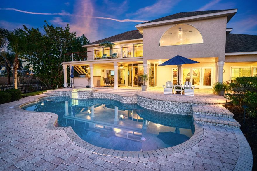 Welcome to "Serenity on Surfside '' with amazing sunsets and endless panoramic views of Tampa Bay, Downtown Tampa/Downtown St Petersburg’s Skyline as well as the Landmarked “Skyway Bridge”. This amazing Custom Built 4 Bedroom, 3.5 Bath home is situated on over an 1/2 Acre lot with 88 feet of Waterfront directly on Tampa Bay and (no right-side neighbors)! As you enter the home through custom double doors, you are greeted to a stunning "1st floor" open floor plan which includes a owners retreat that offers amazing waterfront views, an elegant shower and bath area retreat, double vanity/ custom cabinetry.  The formal dining room, kitchen and living room area with fireplace continues with breathtaking waterfront views. Enjoy an upgraded kitchen with custom cabinetry, tile backsplash, stainless steel appliances, granite countertops, eat in kitchen with a wraparound granite bar top for entertainment and two pantries. Additionally, the 1st floor features office space, optional bedroom (or TV Room), oversized laundry room, and a 1/2 Bath. Take the custom spiral staircase to the 2nd floor and enjoy a more than relaxing loft area that overlooks Tampa Bay, two bedrooms with glass sliders allowing direct waterfront views, a full bath and wonderful storage space. A one-of-a-kind, 2nd floor balcony that overlooks the Bay Waters is a tranquil escape and sure to please. Vinyl flooring is throughout the home and tile bathrooms as well as elegant glass doors on showers. The outdoor living space is spectacular, with a resort style brick pavered custom pool/ spa area, over 65ft of covered lanai space, outdoor kitchen with refrigerator, propane grill, large green egg, sink and granite counter tops. Enjoy a home with numerous maintenance upgrades and necessary features including: Two Rheem A/C Units, Two Rheem Water Heaters, Water Softener, Hurricane rated/Heat resistance sliders, Surge protectors on main electrical panel, Garage with epoxy flooring and Slate wall storage, Wired for generator, Pool wired for heater, Covered boat dock with two lifts (12k and 5k), Sitting area, water/ electricity, New seawall and Riprap. Be on vacation daily as this home is located next to the Apollo Beach Nature Preserve and conveniently located near some of the best restaurants, shopping, major highways (I-4, I-75). For the Ultimate Waterfront Living and Lavish outdoor Lifestyle- This is your home!