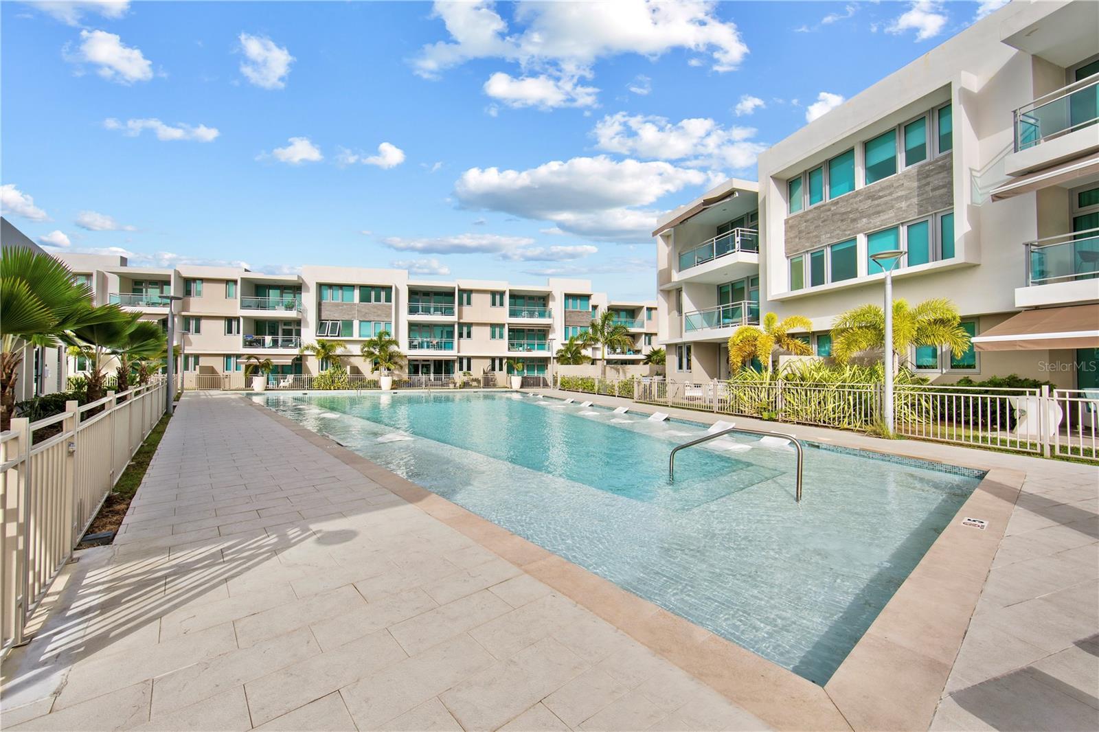 Style, Ease, and Income Potential near Isla Verde Beach.
Just a short hop from Isla Verde's lively beach scene, this stylish apartment stands out for its thoughtful upgrades, breezy design, and easygoing island character. Located in a new condominium completed just two years ago by a respected local developer, the home has recently been enhanced with refreshed bathrooms, subtle kitchen improvements, and design-forward furnishings that reflect the island’s relaxed elegance. The interiors embrace a palette of soft blues, sun-washed neutrals, and modern textures; coastal with a sleek, contemporary twist.
Though the complex sits just across the main thoroughfare from the beach, its location delivers the best of both worlds, moments from the Isla Verde shoreline and just a couple of minutes from the San Juan International Airport. Two conveniently placed parking spaces make coming and going effortless, while full-building backup systems -a generator and water cistern- ensure uninterrupted island living, no matter the weather. The grounds themselves feel like a private resort, complete with multiple sparkling pools, a sleek fitness center, a vibrant playground, and even a dedicated dog park, all secured by 24/7 guarded access.
Perhaps most enticing of all is the flexibility this community affords: with no rental restrictions, the apartment becomes not just a serene personal retreat but a savvy short-term rental investment. In an area synonymous with tourism and beachside leisure, the income-generating potential is as attractive as the property itself. With the freedom to rent as you please and all the perks of a resort-style community, this is island living with ease, style, and serious investment appeal.