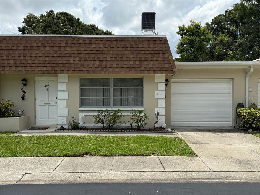 PRICE IMPROVEMENT! Come see this quaint spacious villa offering plenty of storage! This quiet 55+ community offers shuffleboard, community pool, and a clubhouse. Beautiful 1 BR /1.5 Baths well maintained Villa with attached 1 car garage and BONUS room comes FULLY FURNISHED! A NEW roof (June 2025), NEW AC (2024), NEW ceramic tile (2023) throughout the entire living area, NEW Patio pavers (2024), and an updated electrical panel (2021) are just some of the upgrades that you will find in this beautiful villa, that is as clean as can be! This villa sits on a premium lot as you will step out and enjoy the privacy of having NO rear neighbors - great open space with all of the greenery and a great view of the community pond at a distance! This Villa is a one floor unit which means no noisy upstairs neighbors.HOA fees INCLUDE roof, cable, internet, exterior maintenance, cable, water, sewer, trash, escrow reserve fund, pool maintenance - YOU ONLY have to worry about electricity!  Close to everything you could want, yet off the beaten path and tucked away. Convenient central Pinellas location with short drives to beaches and shopping areas.