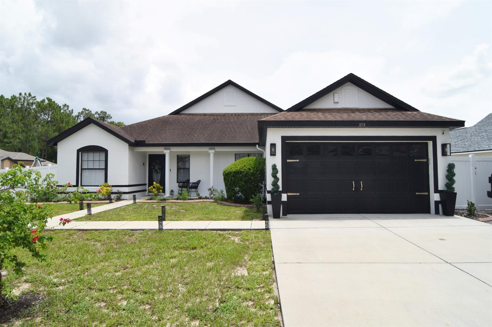 This stunning fully renovated and upgraded 5 bedroom/3 bathroom pool home has a large, fenced backyard and is located on the sought-after Thousand Oaks community with low HOA fees, lakes and community events, plus a great location close to stores, dining and just a 20-minute drive to Disney World! This exceptional corner lot home has been fully updated over the last two years and features a wealth of upgrades including all-new bathrooms, kitchen, flooring, paint, pool resurface, hurricane sliding doors, perimeter fence, irrigation system and more.
The welcoming front porch leads you into the entrance hall and open-plan living space with porcelain tiled floors, vaulted ceiling, lounge area with feature wall, hurricane-proof sliding doors (2024) and views out to the pool deck and fenced backyard.
The formal dining area is located next to the new kitchen (2023) with quartz counters (two waterfall edges) and breakfast bar. GE Cafe appliances can be negotiated separately, otherwise home will come with new stainless-steel stove, dishwasher, microwave and fridge-freezer.
The primary suite leads off from the lounge area and has luxury vinyl planking, walk-in closet, views to the pool deck and an en suite bathroom (2024) with a walk-in shower, twin sinks and WC.
Bedroom 2 is located at the front of the home and is right next door to the new (2025) family bathroom with tub/shower. Bedroom 3 is also at the front of the home and is currently used as a home office.
Bedrooms 4 and 5 are located on the opposite side of the home with a family bathroom conveniently located between the two rooms - this beautiful bathroom with tub/shower has just been installed in 2025. Bedroom 5 has hurricane-proof sliding doors (2024) out to the pool deck.
Step outside onto the gorgeous south-facing private pool deck with 30 x 15 ft pool (6ft depth at the deep end) and spa (pool resurfaced 2023, new pool pump 2022). There is a shaded seating area and a spacious lanai area for sunbathing. The lanai also leads out onto the large lawned garden with new perimeter fencing (2023) and upgraded weather sensor irrigation system (2025).
The home has a driveway for two vehicles at the front of the home, with an additional parking area for a third vehicle to park to the right of the driveway, plus a double garage with door opener (2024). The garage is also home to the laundry area with washer and dryer included.
The home is sold unfurnished. Sellers are open to separate negotiation on furnishings. The roof was replaced in April 2017. A/C replaced September 2016. New wall outlets installed throughout in 2025. This home has been in the same family since it was built, and pride of long-term ownership shows in the level of care and upkeep throughout.
Located on the sought-after Thousand Oaks community with low HOA fees, regular community events and a number of lakes within the community where residents can undertake water sports and fishing, enjoy evening walks and watch the sun set over the lake. This home is in a great location close to shops, grocery stores, dining, easy access to the I-4 and Hwy 27, plus just 11 miles/20 minutes' drive to Disney World! It's the ideal property for long-term residents, as a vacation home, a short-term rental or investment property.