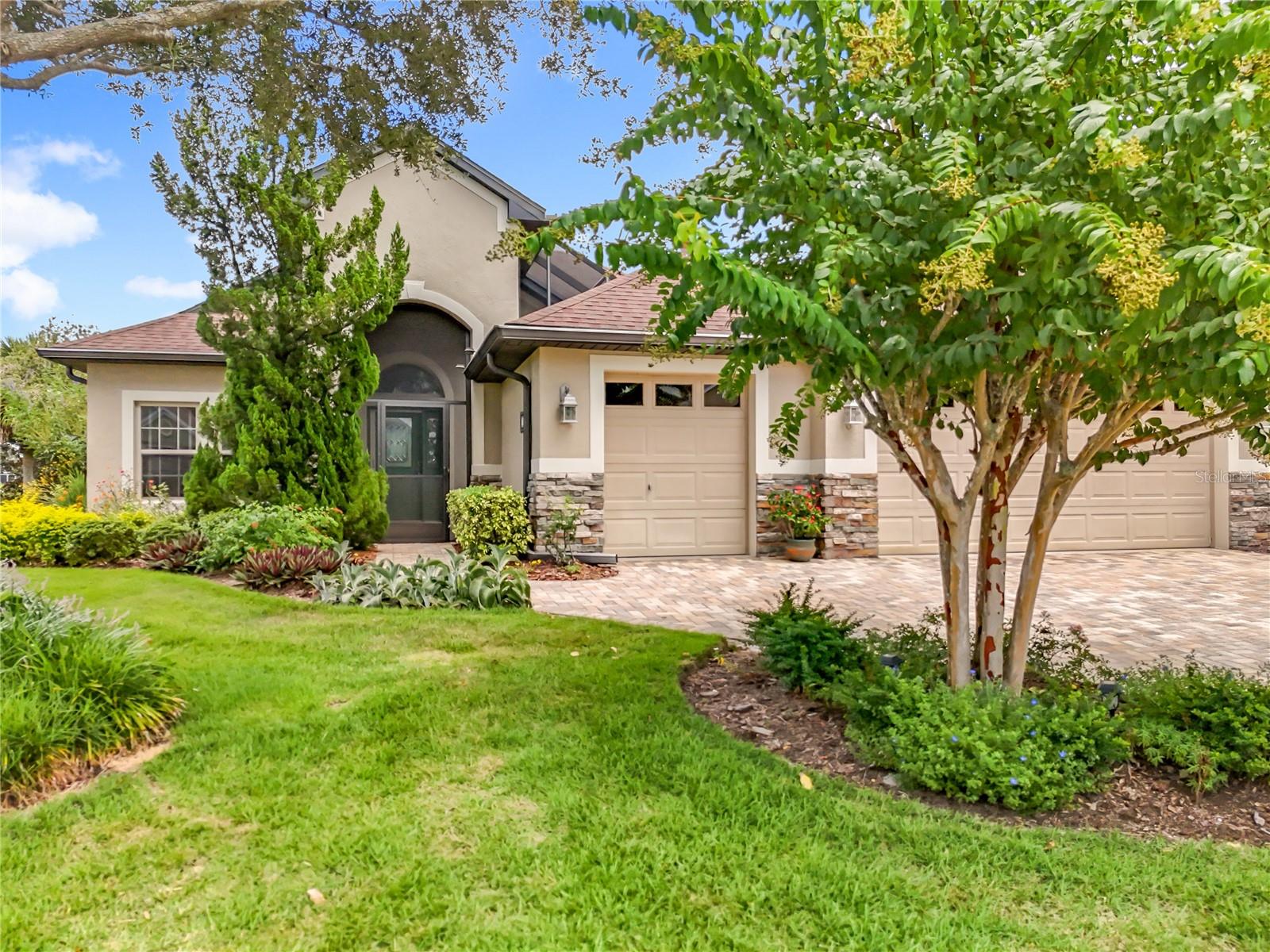 Welcome to a home where style, warmth, and neighborly charm come together - a stunning three-bedroom, two-bath retreat designed for living your best life. As you approach the front entrance, you are welcomed by a charming private courtyard - your first hint of the beauty that awaits inside. Step through the door and your eyes are immediately drawn past the open floor plan to the sparkling water and picturesque island beyond. The heart of the home is a spacious, cabinet-rich kitchen, perfect for both everyday living and entertaining. The serene primary suite features a lovely bay window overlooking a vibrant butterfly garden. With a smart split-bedroom design and an incredible nine closets throughout, this home effortlessly combines beauty, comfort, and functionality.
Nestled in the sought-after Lakes of Mount Dora, this gated community offers an unparalleled lifestyle. Amenities include an 18,000-square-foot clubhouse, a resort-style pool, a hot tub, a billiards room, arts and crafts spaces, and outdoor recreational facilities like bocce ball, pickle ball, tennis, and croquet lawns. Enjoy walking trails, an outdoor fire pit, and countless clubs, events, and travel opportunities. Located just minutes from historic Mount Dora, you’ll have access to a vibrant community known for its art festivals, craft fairs, seafood festivals, and seasonal events like the Fall Light Up. Don’t miss your chance to own this exceptional lakefront property in one of the area’s most desirable 55+ communities!