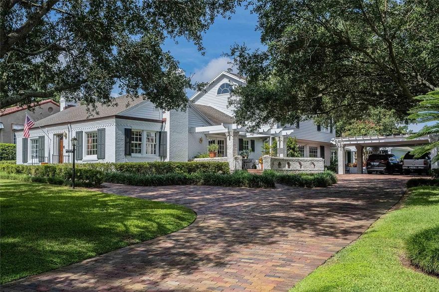 Lake Hollingsworth Treasure! This spectacular home is one of Lakeland’s most recognizable homes. Pristinely situated on a .70 acre lot just steps from Lake Hollingsworth with magnificent landscaping and lake views from many rooms.Boasting over 4000 sf of timeless and charming living space, 5 spacious bedrooms, 4.5 bathrooms, formal living room with gas fireplace (natural gas), dining room, large family room that showcases paneling made from reclaimed American Chestnut wood, large breakfast room, and office or den.  This home hasn’t changed ownership in over 60 years, and has been meticulously maintained. Additional features include: whole house generator, magnificent trim work, multiple master suites on the ground floor, brick and wood flooring, large pavered circular drive providing plenty of parking space, interior safe, exterior insulated equipment room, and tankless gas water heaters.