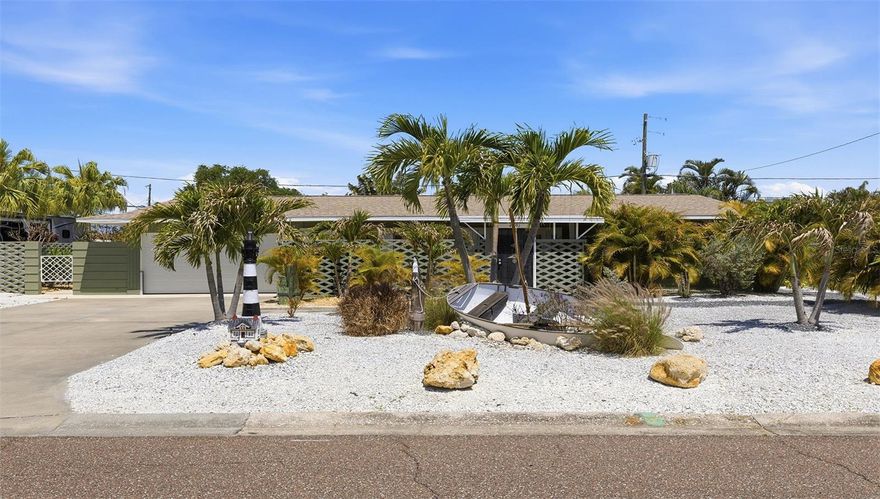 As you pull up to this impeccably landscaped front yard, you're greeted by a striking coastal oasis: gleaming stone, swaying palm trees, and a charming boat-themed lighthouse feature right by the entrance. Step through the front door into a sun-drenched, open floor plan where a seamless flow connects the living, dining, and kitchen spaces. The living room, bathed in natural light from floor-to-ceiling windows, invites you to relax with serene views of the tropical backyard. As you walk toward the kitchen, you’ll notice the sleek GE Profile stainless steel appliances, a Wi-Fi stove, and a quartz island perfect for entertaining. From the dining area, step into the master suite, which opens via a sliding glass door to a private patio, complete with an electric hot tub. Each of the three bathrooms exudes spa-like tranquility, while the tropical backyard dazzles with turf, a saltwater pool, and a gated dog run. With a new hurricane-rated garage door, a 5-year-old HVAC, and golf cart parking, every detail has been thoughtfully curated. Welcome home—this is Florida living at its finest.