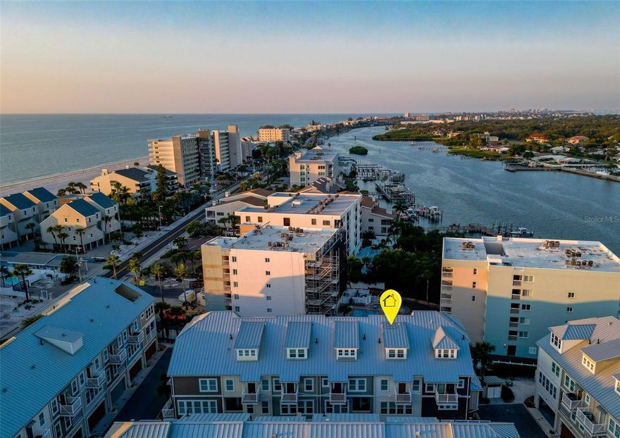 Now is your time to live the good life at Waterside of Indian Shores!
This 4 level townhouse with Gulf and Intercoastal views includes 4 bedrooms and 4 baths, is 2,236 sq/ft and fully and tastefully furnished. A boat slip with 10,000 lb. lift is available for an additional $150,000. The home is newer constructed and solid with concrete block on all 4 levels, pilings to bedrock, metal roof, and Miami-Dade storm-rated windows/doors, offering  peace of mind and luxurious comfort. A private elevator services all four floors, leading to a chef’s kitchen featuring solid wood cabinetry, quartz countertops, a gas range, and stainless-steel appliances. The open-concept design flows seamlessly onto multiple balconies, providing views of both the Intracoastal Waterway and the Gulf of America. High-end Restoration Hardware and Crate & Barrel furnishings are included, making it truly move-in ready—even the kayaks, and beach gear convey with the sale! The 2017 Sea-Doo Jet Skis are included with the highly sought-after boat slip and 10,000 lb lift if purchased separately. A spacious fourth-level bonus room (potential 4th bedroom) and an oversized 3-car garage provide ample space and flexibility. Enjoy community amenities like a heated pool and grilling station, walk directly across Gulf Blvd to the white sandy beaches to take in the most amazing sunsets you have ever seen. Waterside is close to so many popular restaurants, shops and more! Just 40 minutes to Tampa International Airport and an even closer drive St. Pete/Clearwater Airport. Explore all of the unique beach towns, spectacular views, boating, fishing, snorkeling, paddle boarding, wildlife viewing and so many more activities living in famous Pinellas County - the best of the Florida coastal lifestyle. Schedule your private showing today!