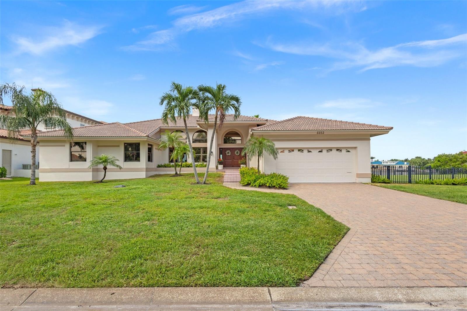 This meticulously maintained property offers 100 feet of prime waterfront on the highly sought-after Bayway Island 2! Enjoy stunning sunsets from the private sitting area or patio of your luxurious master suite. The home has been systematically updated and upgraded from 2019 to 2024, including a brand new dock in 9’ deep water with new wrapped pilings and 13,000lb boat lift, HVAC units, water heaters, impact exterior doors, kitchen cabinets with stainless steel appliances, and much more. Key features include a barrel tile roof, a fence that encloses both the backyard and the neighboring property, two EV chargers, a home audio system with in-wall and in-ceiling speakers throughout, and smart home technology for effortless control of lights, thermostats, pool systems, irrigation, and more—all accessible via your phone. Airy 13' ceilings with high windows allow ample natural light to enhance the spacious living room and formal dining room. The entertainment nook (complete with a wine and beverage cooler) and large covered patio overlooking the pool deck are perfect for entertaining guests. Located in the exclusive Bayway Isles, this home offers unparalleled security and peace of mind. With a security guard on duty 24/7, Bayway Isles boasts the lowest crime rate in Pinellas County. The active Bayway community offers various networking and social opportunities, making it more than just a neighborhood. Step out onto your private dock with deep water access, ideal for boating and soaking in the serene surroundings. The seawall is in excellent condition, ensuring long-lasting waterfront security. The master suite is a true retreat with its own private patio, freestanding soaking tub, and steam shower—the perfect combination of luxury and relaxation. For added versatility, the fourth bedroom makes a spacious office, offering both privacy and convenience. The kitchen is both inviting and functional with plenty of prep and cabinet space, full 24” deep storage on both sides of the island, door-in-door refrigerator with craft ice, and sleek finishes that make both cooking and entertaining a breeze. The one-level design ensures seamless movement throughout the home—no steps, no floor thresholds or transitions, just open, accessible living—and the two-car garage offers additional overhead storage space. This location boasts a close-knit neighborhood community and excellent nearby schools like Shorecrest, Canterbury, Admiral Farragut, and Berkeley Prep, all offering top-tier education. The famous Pass-A-Grille Beach and St. Pete Beach are just five minutes to the West, while easy access to 275 and downtown St. Pete are to the East, making this home the perfect balance of tranquility and convenience.