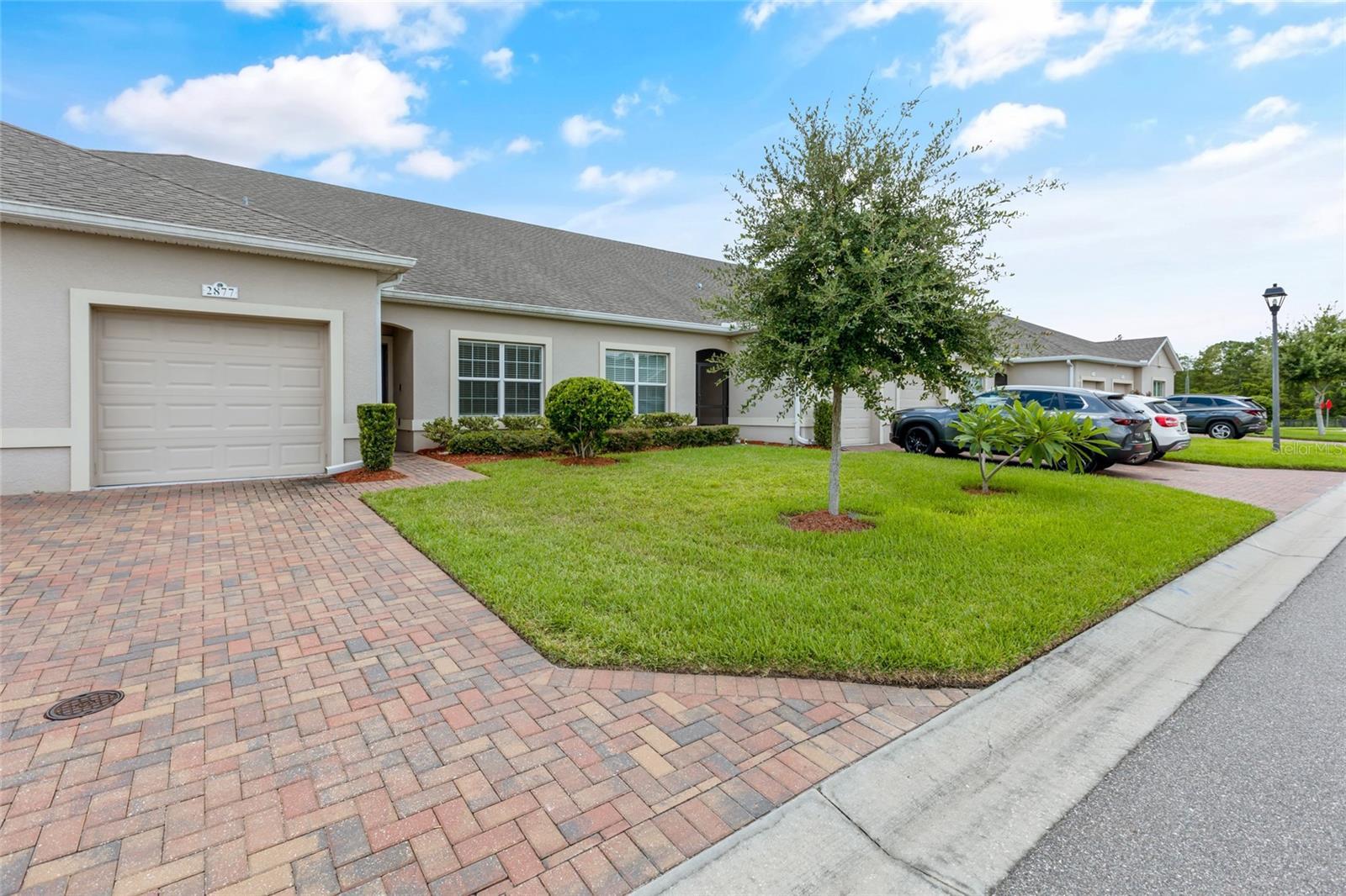 Welcome to this charming 2-bedroom, 2-bathroom villa, nestled in a serene 55+ community. Enjoy a low-maintenance lifestyle with plenty of amenities and services included in your HOA fees. The spacious floor plan offers a cozy sitting area at the kitchen counter, perfect for casual meals or entertaining guests. The master bedroom boasts a generous walk-in closet and an ensuite bathroom featuring dual vanity sinks for added convenience. The back porch is screened in, offering a peaceful space to relax without the worry of backyard neighbors, providing ultimate privacy. A separate laundry room adds to the home’s functionality and ease of living. With nearby mailboxes and a prime location just 3 miles from Regal Eagle Ridge Mall, Aldi, Chili's, Publix, and major attractions like Peppa Pig, Legoland, and Bok Tower, you'll have everything you need at your doorstep. The HOA fees cover a variety of essential services, including roof maintenance and repairs, cable, internet, exterior paint every 5 years, termite control, lawn maintenance, irrigation repairs, and exterior home insurance. The exterior home insurance provided by the HOA can significantly reduce your personal homeowner’s insurance costs, as it covers a large portion of the home’s exterior structure. This can make your insurance premiums lower compared to other homes in the area. Plus, enjoy a wide range of amenities such as a community pool, hot tub, library, aerobic room, basketball court, pickleball court, sauna, gym, billiard room, and a ballroom perfect for hosting events and parties. This villa offers not just a home, but a lifestyle. Make it yours today!