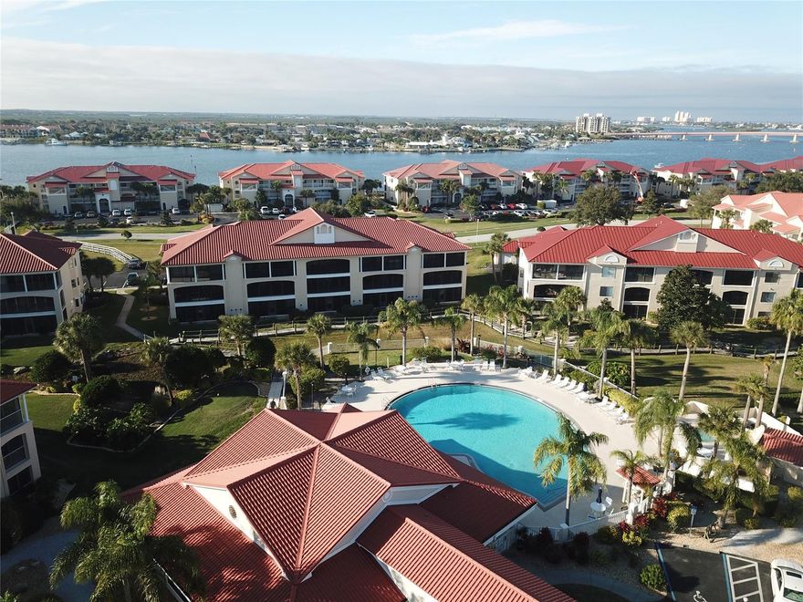 Beautifully maintained 2 bed/2 bath second floor condo with views of the POOL and TENNIS courts in the INTRACOASTAL community of Bouchelle Island.  This spacious feeling condo offers a tiled entryway leading into a great room with CATHEDRAL ceilings, berber carpet, and glass sliders that open onto a porch with "no see" screen for added privacy.  Upgrades include PLANTATION SHUTTERS, window treatments, Kohler toilets, updated glass sliders and more.  Kitchen is open to the great room with a breakfast bar, tile counters, built in microwave, newer dishwasher, and laundry closet.  Bouchelle Island is centrally located to shopping, restaurants, beach and Flagler Ave.  The community has 2 heated pools, tennis courts, clubhouse, fitness room, 18 hole pitch and putt golf course, private boat ramp and storage, boat dock and boardwalk.  Bring your swimsuits and clothes and start enjoying life! ;Water: City