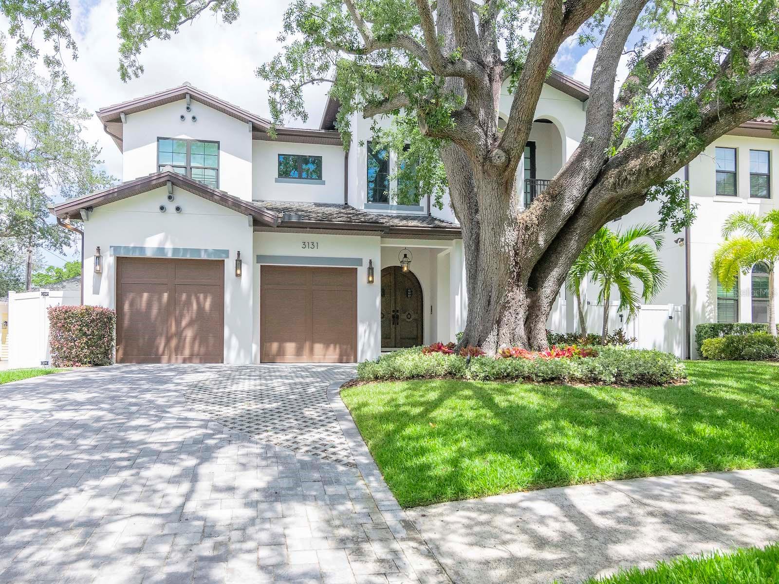 Under contract-accepting backup offers. Submit all offers, seller will choose highest and best. Welcome to this truly exceptional one of a kind Modern Spanish style estate situated across from the iconic Waverly Park in South Tampa. This is your opportunity to acquire a custom home that lives like new construction. This timeless & elegant residence was custom designed, built and completed in 2018 by Devonshire Custom Homes. You immediately get the sense of grandeur as you enter the arched wooden doors and step into the double-height foyer boasting a soaring open space adorned with a hand-forged iron chandelier created by Dana Creath and natural sunlight beaming through the multi-pane window. Open to the foyer is a private dining room featuring a coffered ceiling, Christian Lacroix window treatments, handmade wrought iron fixture, French doors to the terrace, and picturesque views of Waverly Park. The Butler’s pantry which connects the dining room to the kitchen is a delight while entertaining and includes a pocket door for privacy, quartz countertop, wine fridge, floor to ceiling wood cabinetry, sink and walk-in pantry. The spacious kitchen will delight any chef with the design, quality and amenities expected in today’s most luxurious kitchens. The expansive quartz island with custom edge and an abundance of storage, floor to ceiling wood-cabinetry including glass display doors on the top tier, an impressive appliance package that includes a Thermador gas 6-burner range, double ovens, double dish washers, 5 ft wide refrigerator/freezer, microwave plus convection oven, warming drawer, breakfast nook with built in storage, bench seats, custom cushions & window treatments. Adjacent and open to the kitchen is the great room, boasting a dining area, volume ceilings, recessed lights, crown molding, custom window shades, full bath, French doors, and captivating views of the outside oasis. The backyard Oasis features pavers, tongue and groove ceiling, ceiling fan, recessed lights, outdoor kitchen with grill, sink and mini fridge, surround sound, automated heated saltwater pool and spa, infinity edge flows into pool from spa, colored pool lights, flowing waterfalls and geyser fountains, custom up lighting, areca palms and birds of paradise surround the pool, and Astroturf on each side of the house are all enclosed by a white vinyl fence. The downstairs generous laundry room, storage closet, mud room and 2 car garage with overhead storage are tucked away under and to the left of the staircase. Upstairs you will find volume ceilings, crown molding, custom shades, an open loft area with a coffee bar, sink, fridge, cabinets, 4 bedrooms & 3 full bathrooms, and a secondary laundry room with ample storage/cabinets. The primary suite provides a serenity experience with the outstanding layout, terrace/balcony, custom sliding door to the master bath, dual sinks, expansive quartz counter tops, lovely sconces, separate vanity, oversized shower with bench, shelves, multiple shower heads including rain shower, intimate free standing soaking tub, speakers and mounted tv’s that have access to streaming service through Elan, fabulous glamorous walk-in closet with built-ins, glass and mirrored doors, mirrored backsplash & custom-cabinets to the ceiling, The second bedroom is ensuite and has a private balcony/terrace overlooking the park. Bedrooms 3 and 4 share a Jack and Jill shower, tub & toilet but were designed to each have a private sink with quartz countertop for convenience & privacy.