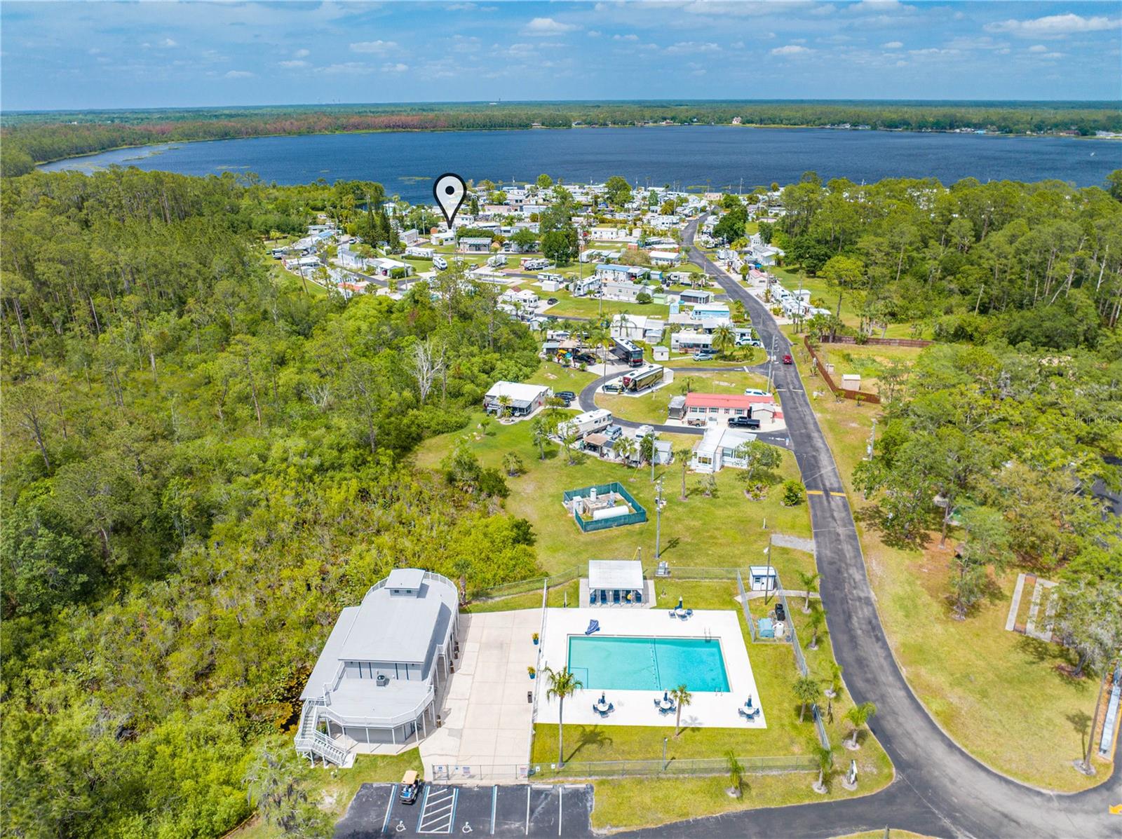 SHELTER COVE, GATED COMMUNITY situated on Center Lake with direct access to the Chain of Lakes. Vacant Lot with new Concrete Pad and Storage Shed. Camper not included in sale. Tucked within a sprawling 150-acre community, Residents enjoy an array of amenities including a community pool, clubhouse, boat launch, walking trails, shuffleboard, basketball court, fitness center, and laundry facilities. The monthly association fee of $180 covers water, sewer, and trash services. Spacious lot, currently rented for $800/month with lease expiring January 31, 2026. Ideal for snowbirds or savvy investors, there are no age restrictions or minimum rental periods. Community allows park model mobile homes, campers, and RV's. Prospective tenants undergo a thorough background check. Call today to schedule your showing!
