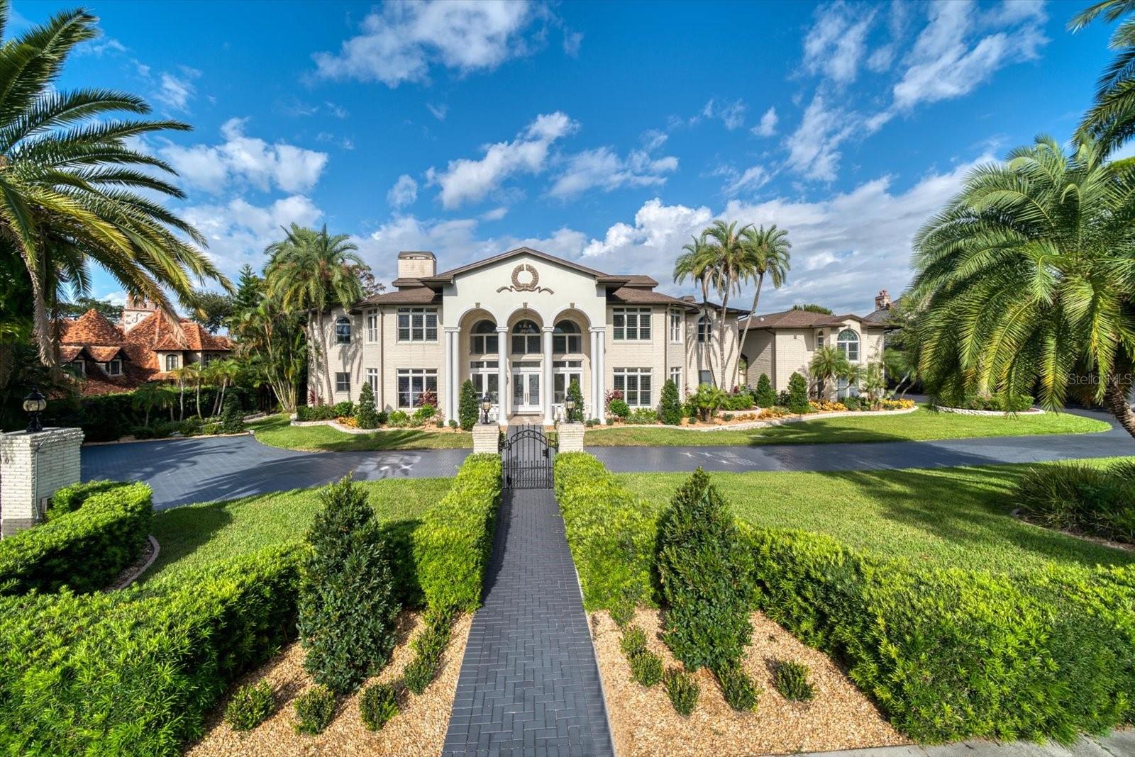 RARE OPPORTUNITY: Intracoastal 15,000+ SF grand waterfront estate on Willadel Drive in Belleair with large open water views of Sand Key, Clearwater Harbor, and the Gulf of Mexico! An unforgettable picture-perfect appeal, this remarkable brick mansion boasts 1.82 acres of beautiful layered landscape that transitions brilliantly to the waterfront and brand new seawall. A new dock in the private marina complete with 2 slips. Massive circular drive with two automatic security gates welcomes you to a phenomenal estate with towering 21 foot high ceilings, wonderful open spaces, magnificent and complex detailed woodworking and sweeping panoramic water views. Choose from Two Main Suites – one on the ground floor and one on the second floor. For ultimate privacy, there is a separate guest apartment above the Garage. New roof completed October 2022.