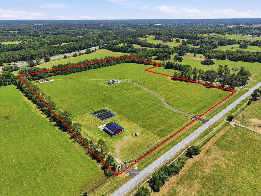 This exceptional custom-built estate (with immediate multigenerational possibilities) offers quality construction, modern upgrades, and incredible versatility on over 27 acres zoned Agricultural. Built with durability and efficiency in mind, the home features 2”x6” exterior walls, a stem-wall foundation, spray foam insulation throughout (including attic and porches), and a metal roof. Inside, enjoy 10’+ ceilings, 8’ solid core doors, tray ceilings, upgraded lighting, and luxury vinyl plank flooring throughout.

The kitchen is beautifully upgraded with dolomite countertops, tile backsplash, and under/upper cabinet lighting. Bathrooms and entryway showcase Taj Mahal quartzite countertops and tile finishes. Additional features include upgraded plumbing fixtures, insulated garage door, prewired Ethernet at the eaves, UV light well treatment, and fans in bedrooms and living areas.

The property is accessed through custom brick column entrances with lighting, electric outlets, and automatic gates, along with new culverts at both the main and service entrances.

A standout feature is the impressive 30’x60’ pole barn (built in 2024) with two 10’x60’ lean-to porches. Fully heated and cooled with its own HVAC and separate 4”, 5 hp well, this space includes a full bathroom, spray foam insulation, custom lighting, a massive 120” fan, and multiple double doors for easy access. Currently configured as a plant nursery with irrigation, it offers endless flexibility for agricultural, hobby, or business use. This property has been use for hay production for many years.  Additional improvements include a 12’x48’ storage barn with water and electric.

Conveniently located approximately 2 miles from Publix, 6 miles to Downtown High Springs, 17 miles to the University of Florida, and about an hour to both the World Equestrian Center and Florida Horse Park. Easy access to I-75 allows for a smooth commute, with Jacksonville approximately 1 hour 15 minutes away.

This high-end property offers privacy, functionality, and future potential—including the opportunity to expand into a multigenerational estate.