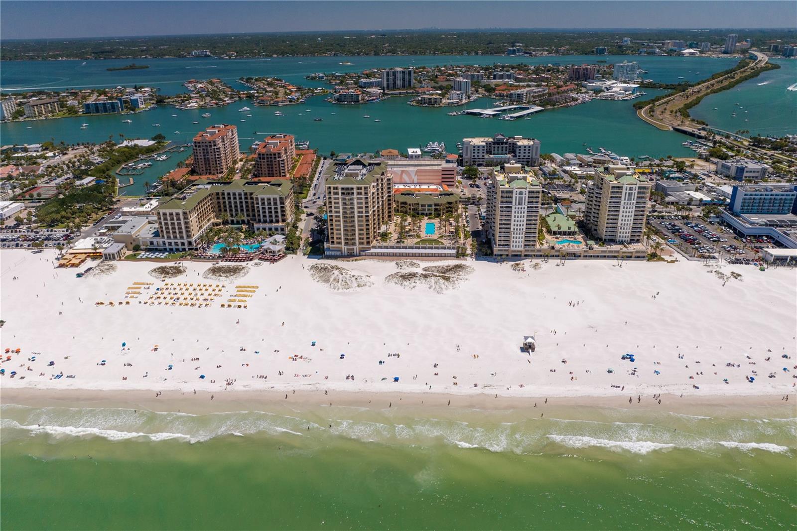 Welcome to the Residences at Sandpearl, the epitome of luxury living on Clearwater Beach. This stunning 4-bedroom, 3.5-bathroom residence boasts over 4,700 square feet of living space and uninterrupted panoramic views of both the Gulf of Mexico and the Intracoastal Waterways.
Step inside and be mesmerized by the open-concept living and dining area, complete with high-end finishes and tons of space for entertaining. The chef's kitchen features top-of-the-line appliances, a breakfast bar, reverse osmosis water filtration to both the refrigerator and the icemaker, and breathtaking views from every angle. The unit also features three large terraces, perfect for watching the sunrise and sunset over the sparking Gulf and Intracoastal waters.
The luxurious primary suite offers a spacious sitting area with built-ins, including two cooled beverage drawers, a spa-like ensuite with double vanities, a jetted tub, a walk-in shower, and 2 walk-in closets. The remaining three bedrooms each have access to a terrace, offering unique and stunning views.
Additional amenities dedicated to this luxurious penthouse unit include 2 assigned under-building parking spaces, climate controlled storage unit, and a beachside cabana perfect for storing all of your beach gear!
Sandpearl Residences is more than just a place to call home. It's a lifestyle, a haven where every detail is designed to provide you with the ultimate in luxury and comfort. The building's exceptional amenities are second to none, ensuring that every day feels like a vacation. From the moment you step inside, you'll be captivated by the stunning architecture, exquisite design, and unparalleled views.
This secure building provides residents with a 24/7 Concierge, gathering rooms, billiards room, conference room, state of the art fitness center, bike storage, whole-building water softener, and a beachside pool with expansive relaxation and entertainment areas. With its perfect location in the heart of Clearwater Beach, you're just steps away from local shopping, fine dining, and the world-famous white sand beaches.
Whether you're looking for a full-time residence or a vacation home, Sandpearl Residences is the perfect choice. This exclusive community is located in one of the most desirable areas of Clearwater Beach, surrounded by breathtaking natural beauty and world-class amenities. Don't miss your chance to own a piece of paradise in this unparalleled oceanfront oasis.