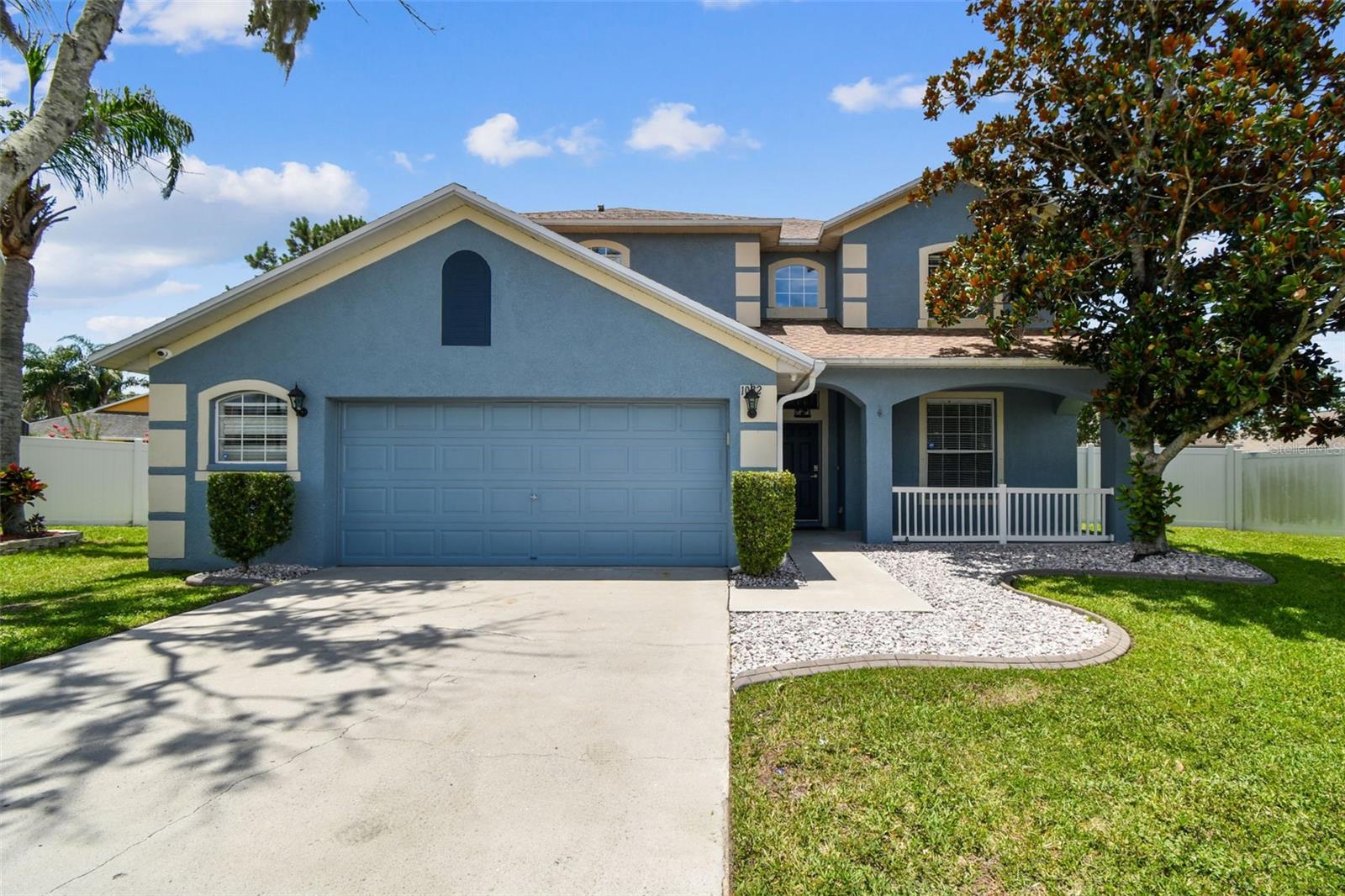 Welcome to this beautifully updated 4-bedroom, 2.5-bath home located in the desirable gated community of Ivy Lake Estates! Nestled on a quiet cul-de-sac, this spacious 2,355 sq ft single-family home has a NEW roof, an oversized 2-car garage, and offers a perfect blend of comfort, function, and modern design. The first level has a bright, open layout with tile floors throughout. The gourmet kitchen is a chef’s dream, featuring 42" soft-close cabinets with upper glass inlays and lighting, a gorgeous backsplash, quartz countertops, a farmhouse-style sink, island with eat-in space, pantry, and a separate wet bar with wine refrigerator—perfect for entertaining. The family room offers sliding glass doors leading out to a large, screened lanai that overlooks an oversized, fully fenced backyard. The private yard provides ample space for outdoor enjoyment or future pool. The formal dining room offers a great space for gatherings, while the additional formal living space can easily serve as a home office or den. The downstairs half bath has modern updates and a door leading to exterior. Modern touches continue with the wood and iron staircase leading to the second level with laminate wood flooring (NO CARPET) The spacious primary suite has dual walk-in closets, ensuite bathroom with double vanities and a luxurious step-in shower featuring floor to ceiling tile and rain head shower feature. Three additional generously sized bedrooms and a fully updated bathroom complete the upstairs space. Amenities of this beautiful community include playgrounds, basketball and volleyball court, and open park areas. Located with easy access to top rated schools, shopping, major roadways, and more. Schedule your private showing today—this one won’t last long!