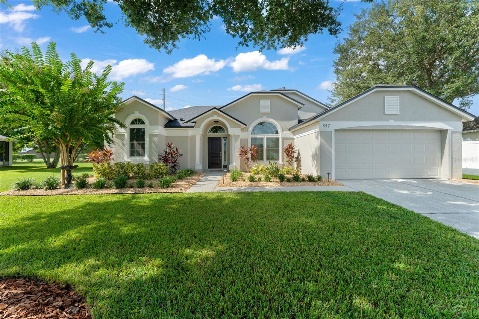**This house comes with a REDUCED RATE through the seller's preferred lender. This is a lender-paid rate buydown that reduces the buyer's interest rate and monthly payment.**Tucked away in the heart of Davenport, this beautifully maintained 3-bedroom, 2-bathroom home offers nearly 1,700 square feet of comfortable living space, a spacious 2-car garage, and sits on an expansive half-acre lot. From the moment you arrive, the impeccable curb appeal captures your attention—lush, manicured landscaping and a mature shade tree create a warm and inviting welcome. This home has seen thoughtful and significant upgrades, ensuring peace of mind for years to come. A new roof installed in 2025 comes with a 10-year transferable warranty, while the kitchen was beautifully renovated in 2024 with premium Cambria quartz countertops. The garage door system and springs were updated in 2024 with a professional-grade Genie opener, and in 2023, the landscaping was refreshed, irrigation valves replaced, and electrical plugs and switches modernized. For enhanced efficiency and comfort, energy-efficient, noise-reducing windows and a new front door were installed in 2022. Step inside to a thoughtfully designed split-bedroom floor plan that offers both privacy and flow. The light-filled family room greets you upon entry, setting the tone for the rest of the home. Just off to the left is the primary suite, a true retreat featuring French doors that open to the backyard patio, a spa-like ensuite bathroom with a step-in soaking tub, floor-to-ceiling tiled walk-in shower, dual sink vanity, and a generous walk-in closet. To the right of the entry, you’ll find a formal dining room, currently used as a home office—a flexible space to fit your lifestyle. Continue through to the heart of the home where the kitchen and breakfast nook overlook the serene backyard. The kitchen boasts white cabinetry with crown molding, stone countertops, stainless steel appliances, and a breakfast bar perfect for casual dining or entertaining. Adjacent is the family room, bathed in natural light thanks to wood-framed glass French doors that open to the patio. Two additional bedrooms with built-in closets and a full bathroom with a tub/shower combo are nestled between the kitchen and living area—ideal for family or guests. The laundry room offers overhead cabinetry and easy access to the garage for added convenience. Step outside to your own private oasis—a fully paved patio with a built-in firepit overlooks the fully fenced backyard, offering a blank canvas for gardening, entertaining, or creating the outdoor space of your dreams. Whether you're relaxing under the shade tree out front or roasting marshmallows in the backyard firepit, 917 Via Bianca is more than just a house—it’s a place where memories are made.