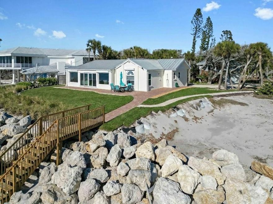 Premier Gulf-front gem on secluded Manasota Key, Englewood—where true privacy meets unbeatable coastal living. This rare two-bedroom, two-and-a-half-bath residence sits on over half an acre, with 100 feet of private beachfront right outside your door—your own front-row seat to sea turtles laying eggs and hatching during season, one of the rarest wildlife experiences anywhere. Plus, a deeded dock slip across the street on Lemon Bay—perfect for calm launches, kayaking, or quick Gulf access. Hard to find anywhere: direct Gulf of Mexico frontage—ideal for sunrises, barefoot walks, effortless boat rides, and legendary shelling on your sand. This stretch is famous for shark teeth finds—big Megalodon fossils included. Surroundings? Pristine, quiet nature—no crowds, just you and the water. Inside, fully refreshed with new impact windows, sliders, and irrigation; outside, fresh sod and new pavers turn the yard into your own private oasis. Detached garage houses a 576-square-foot guest suite—complete with bedroom, bath, kitchen, dining, and living—for guests or quiet getaways. Seclusion, views, and waterfront ease at its best.