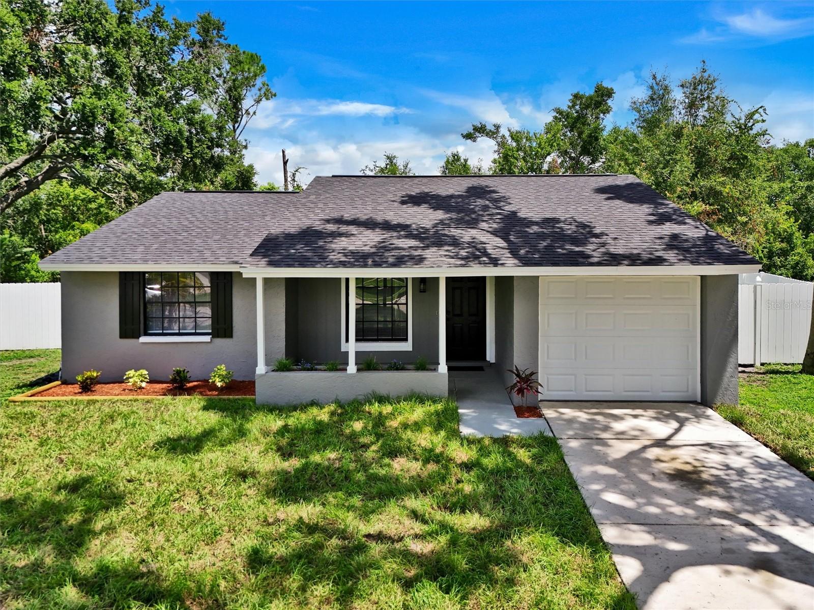 Welcome to your beautifully remodeled Carrollwood home, where comfort, style, and convenience come together in one perfect package. This move-in-ready gem features a brand-new roof, fresh interior and exterior paint, and elegant laminate wood flooring throughout—no carpet in sight. The heart of the home is a stunning custom kitchen with brand-new wood cabinetry, sparkling quartz countertops and backsplash, stainless steel appliances, and a spacious pantry designed for effortless organization. Enjoy the ease of a new stackable washer and dryer, and stay cool year-round with a 4-year-old central A/C system. With three generously sized bedrooms and two fully updated bathrooms featuring quartz counters, new sinks, faucets, and cabinetry, every space has been thoughtfully upgraded. Step outside to a screened lanai overlooking a huge fenced backyard with peaceful conservation views—no rear neighbors and plenty of room for a pool. Whether you're entertaining, relaxing, or storing your boat, RV, or toys, this expansive outdoor space offers unmatched flexibility. Additional highlights include a one-car garage with a brand-new hurricane-rated door and opener, and the freedom of no HOA restrictions. Located just minutes from Costco, Veterans Expressway, Citrus Park Mall, Tampa Bay Trail, hospitals, Raymond James Stadium, and top dining spots, this home delivers the ideal blend of privacy and proximity. All major updates are complete—just bring your suitcase and start living. Schedule your showing today and discover the lifestyle you've been waiting for.