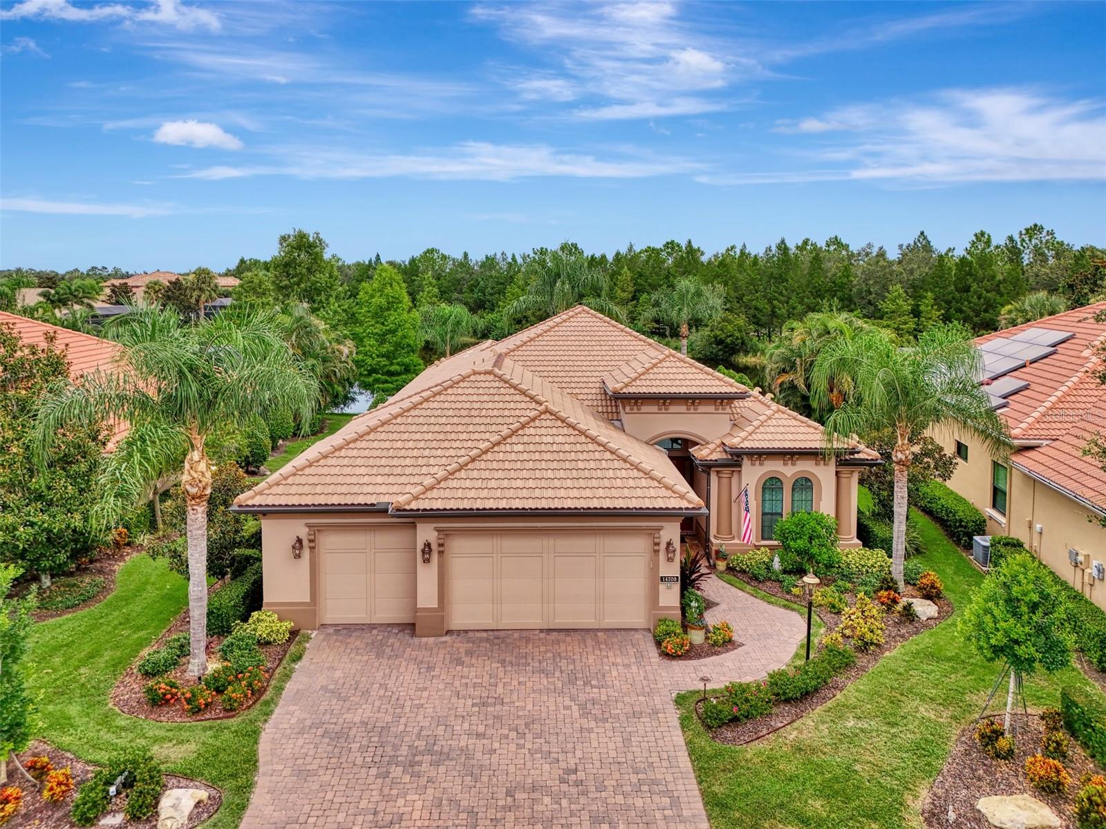 Welcome to luxury living in the exclusive gated community of Country Club East! This impeccably maintained 2,934 sq ft custom Lee Wetherington home is nestled on a serene and private homesite with breathtaking water views, offering 3 bedrooms, an office, a separate workout room/flex space and 2.5 baths. Perfectly blending refined indoor living with a true resort-style outdoor experience, this home is ideal for entertaining or relaxing in total privacy. Designed with quality and comfort in mind, the home features HIGH IMPACT DOORS & WINDOWS, a whole-house generator, tankless hot water heater (2023), and a Trane AC system (2023), whole house water refining system and Reverse Osmosis. DeHart Security Camera System monitors the entire perimeter, complete with a command center and video monitor to be used with Zuum app that is discreetly located in the hall closet. The heart of the home is the gourmet chef’s kitchen, boasting custom cabinetry and top-tier appliances: Wolf oven and microwave, Thermador gas cooktop, Bosch dishwasher, and Uline dual-zone wine chiller. Solid wood shelving in the pantry & wood shelving in all closets elevates organization with a clean, luxurious aesthetic.
The spacious primary suite is filled with natural light and offers serene views, custom closet systems & Duette double view blinds with custom coordinating window treatments. The secondary bedrooms features a Jack & Jill bathroom with double sinks. The large den is perfect as a home office or additional flex space for all of today’s lifestyle needs. The grand great room showcases a stunning coffered ceiling with accent lighting. All lighting in the home has been upgraded to LED. Natural light floods in from the double set of triple sliding doors leading to the lanai. Step outside to your own private retreat featuring a sparkling saltwater pool and spa, raised irrigated planters, natural gas fire pit and color changing pool lighting. The lanai is an entertainer’s dream, complete with a fully equipped outdoor kitchen featuring a Lynx grill and Proline hood and convenient dedicated pool bath.
The 3rd-car garage space has been thoughtfully converted into a home gym with its own EcoBee/Thermostat Energy Saver system. The bonus space can be converted back into garage space. The garage has a separate ductless mini-split system (2023) to keep you and your garage items cool, NewAge garage cabinet system, ceiling-mounted storage, and a chainless LiftMaster door opener (2022) along with a dedicated breaker and switch for the garage refrigerator. The impressive laundry room has an abundance of additional cabinets, and a huge walk in closet along with an additional storage closet.
Luxury finishes extend throughout the home with lit tray ceilings, detailed crown molding, surround sound in the great room, and thoughtfully curated designer touches.
This home has been maintained with pristine care and is an opportunity to own a turnkey, high-end home in the heart of Lakewood Ranch.
Country Club East offers the perfect blend of luxury and lifestyle, with resort-style community pools including The Retreat—featuring a spa, fitness center, outdoor kitchen, and scenic nature trails all in a beautiful and pristine community. This private, gated community provides an unparalleled experience with nearby top-rated schools, world-class dining, shopping, medical facilities, and easy access to I-75. Close to the #1 beaches in the country, Sarasota, St. Pete and Tampa!