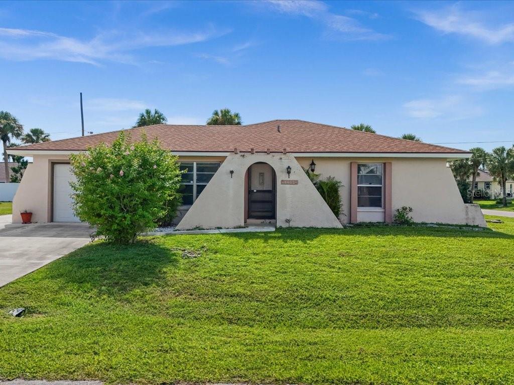 Opportunity Knocking! This 3 bedroom, 3 bath, pool home is centrally located across the street from waterfront homes, is less than 20 minutes from several boat launches, and all Charlotte County amenities. Features include 2 Primary bedrooms each with en-suite baths. The third bedroom is situated near the hall/guest bath. Views of the pool and large screened deck area are visible through the pocketing slider and instantly grab your attention as you enter the home. The tiled Great room, Kitchen, and dinette area complete the main body of the home. All bedrooms have been tastefully updated with newly installed LVP flooring and baseboards. If you LOVE vintage, the all original cabinetry throughout the home is in excellent condition! Enjoy the outdoors on the spacious screened lanai and huge pool deck area surrounding the in ground concrete pool. The Roof was replaced in 2023 and AC replaced 2024. This home offers so much! Bring your ideas and imagination to personalize this truly unique home!! The lot to the rear (MLS# C7513924) is also available for an additional $35K to make an awesome parcel of over a ½ acre spanning corner to corner!