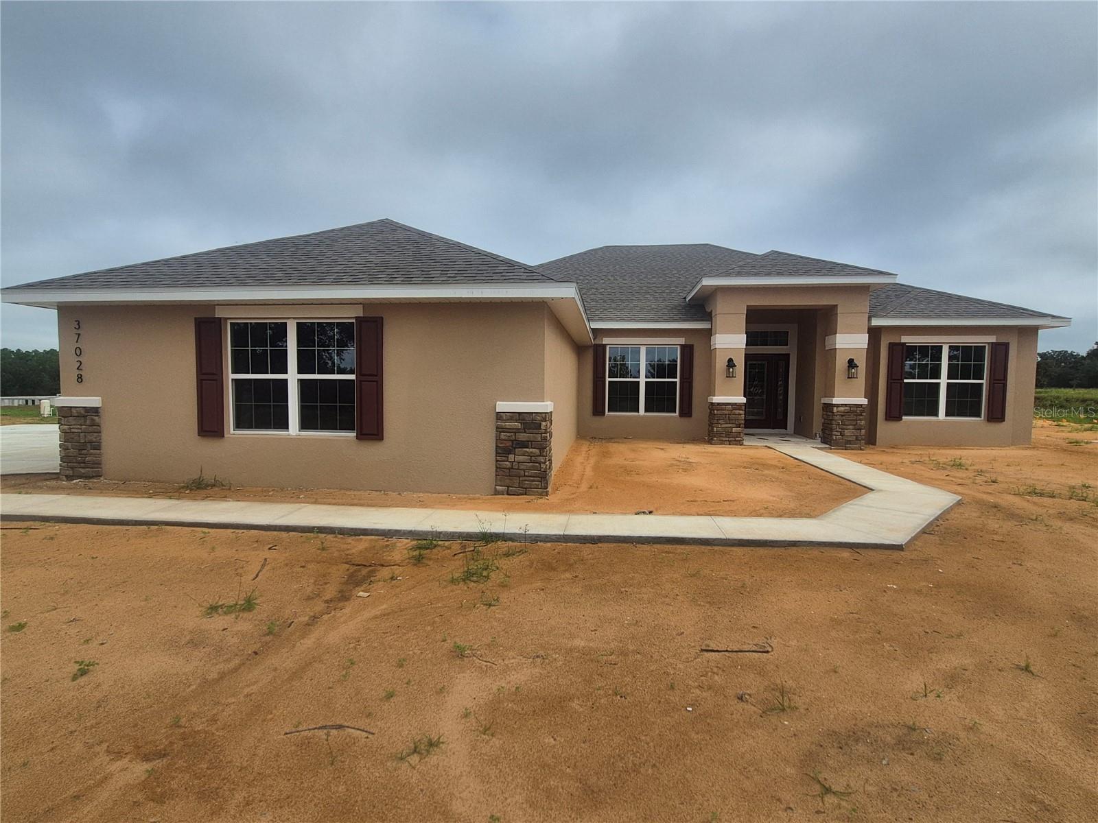 Explore the 2330 by Adams Homes. This 4-bedroom, 2-bath home features a spacious layout designed for comfortable living. A foyer opens to formal living and dining areas, while the family room flows into a modern kitchen with breakfast nook, walk-in pantry, and plenty of counter space. The master suite includes walk-in closets, dual vanities, and a relaxing soaking tub. With additional bedrooms, a laundry room, 2-car garage, and bright, airy spaces, the 2330 combines comfort, style, and practicality.The exterior has stone accents, and the garage doors have top-row windows for natural light. All three bathrooms echo the home’s upscale feel with matching granite counters and soft-close cabinetry. Additional upgrades include 5¼” baseboards, a 50-gallon water heater, double-pane low-E windows, and the peace of mind that comes with no flood zone concerns. Why wait to build? Your brand-new home in Hill Country Estates is ready now—beautifully finished, energy efficient, and move-in ready.