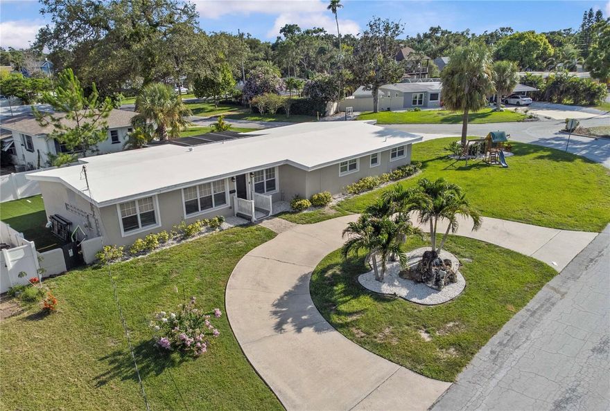 Welcome to this newly remodeled and beautifully updated 3-bedroom, 2-bathroom home with a dedicated office and spacious 2-car garage, located in one of the most sought-after neighborhoods in Pinellas, Belleair! Sitting proudly on a large corner lot of almost a quarter acre, the home greets you with a wide circular driveway that sets the tone for the comfort and ease that follows.

Step inside and you’re welcomed by bright, open living spaces filled with natural light and modern design elements. Luxury vinyl plank flooring guides you from room to room as the living area flows effortlessly into the heart of the home, a stunning gourmet kitchen designed for both everyday living and memorable gatherings. Quartz countertops, a classic subway tile backsplash, sleek stainless appliances, and a stainless steel vent hood give this space a clean and timeless feel.

The primary suite offers a sense of calm at the end of the day with its oversized walk-in closet and beautifully remodeled bathroom featuring a floor-to-ceiling tiled walk-in shower with frameless barn-style glass doors. Two additional bedrooms and a separate office provide room to grow, create, and settle in comfortably.

Step outside and discover a backyard made for easy living. The vinyl-fenced yard wraps around a tranquil rock waterfall fountain, a screened porch, and freshly graded, maintenance-free turf that keeps weekends free for barbecues, family time, or simply unwinding in the sunshine.

Thoughtfully updated interior in 2026 and additional notable updates: new A/C system and ductwork installed in 2021, a new roof, fascia, and soffits - 2017, new windows, top of the line electrical panel and new main water line plumbing, redesigned living areas, refreshed lighting, remodeled bathrooms, new appliances, and turfed backyard. This home has never flooded and stands on its own elevated lot and has had no drainage concerns, adding another layer of reassurance.

Set on a quiet street in a non-flood, non-evacuation zone, this home places you moments from the Belleair Country Club and Pelican Golf Club, with the world-famous Clearwater beaches just a short drive away. This is a place where everyday living feels a little more special.