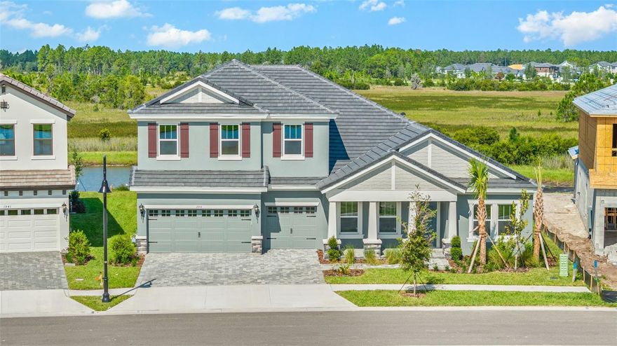 This is the only MOVE-IN READY Key West II model currently available in Two Rivers a rare opportunity to secure the largest floor plan in the community without waiting on new construction. Offering over 3,000 sq ft of bright, open living space, this home is designed for both comfort and functionality. The main level features an extended foyer, den, formal dining room, and expansive grand room with soaring 12’ ceilings that flow seamlessly into the chef’s kitchen and oversized island perfect for everyday living and entertaining. The kitchen comes fully equipped with a gas range, double oven, wine cooler, refrigerator, dishwasher, and microwave, making it ideal for home cooks and entertainers alike. Tile flooring runs throughout the first floor, while the second level offers carpeted comfort. A spacious owner’s retreat on the lower level includes a spa-style bathroom and oversized walk-in closet. Two additional bedrooms and a full bath are also located downstairs. Upstairs you’ll find a versatile bonus room, fourth bedroom, and another full bath ideal for a guest suite, office, or media space. Enjoy outdoor living on the covered lanai with beautiful pond views right from your backyard a serene backdrop for morning coffee or evening gatherings. Two Rivers is a thoughtfully planned community with scenic nature trails, outdoor recreation, and convenient access to Wesley Chapel’s shopping, dining, and schools—all within an easy drive to Tampa’s business, entertainment, and cultural districts.