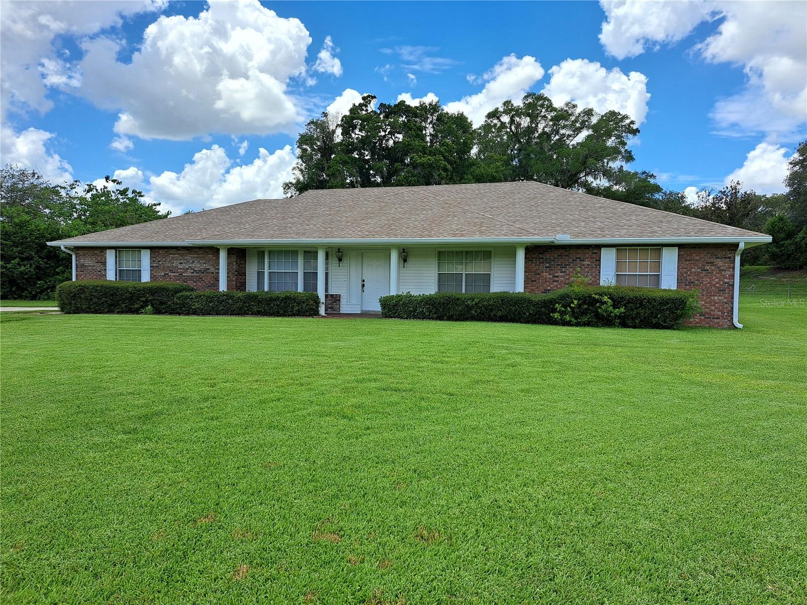 Located within 1 mile of schools, and shopping this stunning well preserved home sits on over ½ acre in one of Marion County’s southwest tucked away subdivisions, Country Oaks. The home has 2,597 square feet of living space and features , a manicured landscaped yard, a real brick front, a grand entry with a light paneled front entry door, cathedral ceilings with wood beam accents, a very open floor plan, a huge sunken floor great room with a wood burning fireplace and a wet bar. The open eat in kitchen area has lots of counter space, a peninsula bar, beautiful cabinetry and a big breakfast nook. There is also a separate formal dining room with a bay window just off of the kitchen. The massive master suite has French doors that open to the sunroom, a double sink vanity, a pedestal tub, a separate toilet room, a stand up ceramic tiled shower and a large walk in closet. There is an inside laundry room that has a double bi-fold door pantry and a mop sink. Just off of the laundry room is one of the homes full bathrooms. There is an enclosed sun room that is centrally heated and cooled, a back porch that is window enclosed and a separate screened in porch. The oversized side entry garage is big enough for 2 cars and still have enough room for a work shop. This is an amazing property, a definite must see.