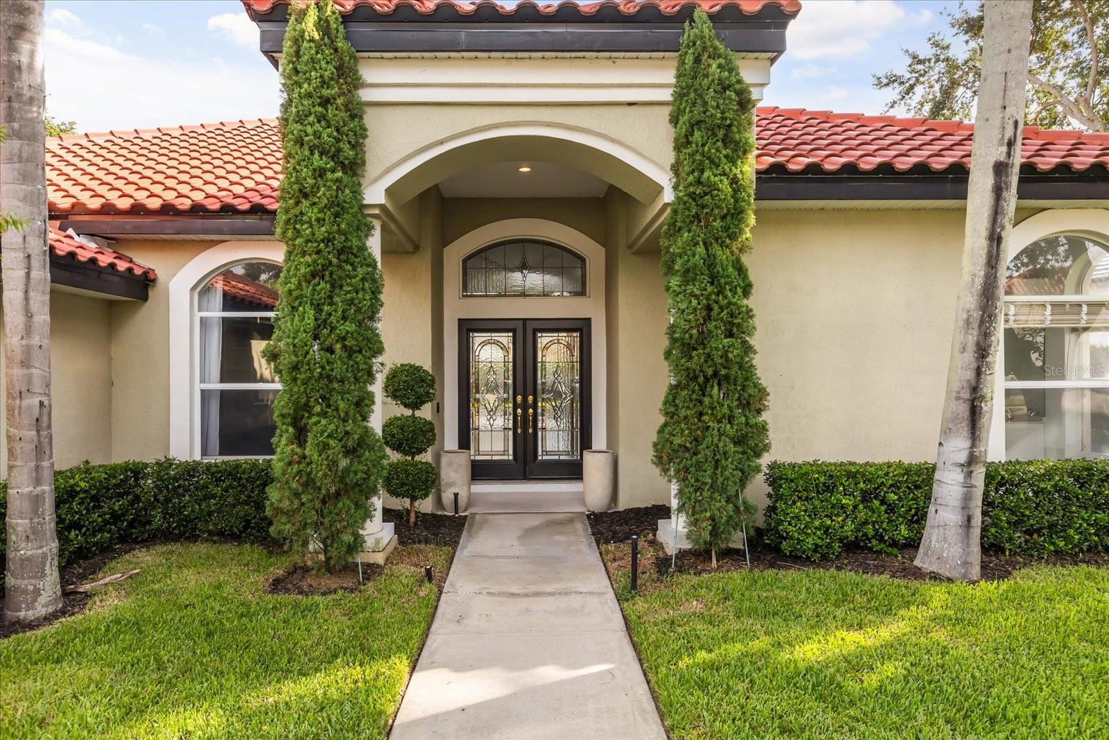 Tucked within the 24/7 guard-gated enclave of Heathrow, this elegant Lake Mary residence offers more than just a place to live—it delivers a lifestyle of comfort, convenience, and refined Florida luxury. Overlooking four picturesque holes of the championship Heathrow golf course, the home blends timeless design with modern features, from crown molding and French door entry to an expansive open layout perfect for everyday living and entertaining.
Start your day in the sunlit home office with custom built-ins, unwind by the heated saltwater pool and spa, and entertain with ease in the gourmet kitchen featuring stainless steel appliances, a large island, and effortless flow into the family room with fireplace and built-in shelving. The layout includes four bedrooms, two with private en-suite baths—one offering direct pool access—plus a half bath for guests and a full laundry room with washer, dryer, sink, and storage.
Outdoors, enjoy a screened lanai, fenced yard, and ceiling fans to stay cool on summer days. Additional perks include a 3-car garage with EV charging, ample storage, and a circular driveway with parking for up to 8 vehicles. Lawn care, pest control, shrub maintenance, and weekly pool cleaning are included.
As a resident of Heathrow, you'll also enjoy access to community amenities such as a fitness center, resort-style pool, playgrounds, basketball courts, baseball and soccer fields, serene walking trails, and fishing lakes. This is luxury living, redefined—set in a vibrant, amenity-rich community with everything at your doorstep.