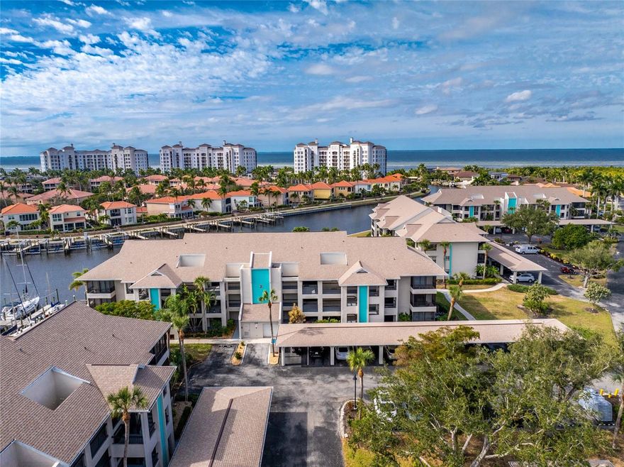 Nestled within the sought-after Marina North Shore at Burnt Store Marina, this ground-level end-unit condo delivers the effortless Florida lifestyle so many buyers are searching for. Just steps from the north marina basin and community pool, so you can walk straight out your door for a swim or hop on your bike or golf cart and explore the marina community with ease. Designed to maximize light, airflow, and indoor-outdoor living, the home features both a front screened entry lanai and a rear screened lanai with sliding enclosures. Slide open the glass doors and enjoy the tropical breezes while still enjoying the laid back vibe at Marina Northshore. The front lanai not only allows for a refreshing cross-breeze, but is a great place to welcome your guests inside.  It also offers a generously sized storage closet for your recreational gear. Inside, you will love the kitchen window &  large dining room window that frames the park-like side yard and fills the home with pleasing natural light. The open kitchen is well configured and offers newer appliances, an extensive breakfast bar, work surface and storage that is ideal for casual dining or entertaining, along with under-cabinet lighting that adds both function and ambiance. The generously sized primary suite opens directly to the lanai, creating a private retreat with seamless access to the outdoors. The en-suite bath features an expansive vanity with dual sinks, glass-enclosed shower and a window to welcome in fresh air. A thoughtfully positioned guest bedroom suite enjoys privacy from the main living space and its own private screened lanai, perfect for visitors or a peaceful flex space. A UV filter was added to the AC (6 years old) in 2025. The furnishing package is optional. Residents enjoy a convenient covered carport right outside their door, as well as ample guest parking.The complex offers newer roofs and exterior paint as well as a heated pool with attractive paver pool deck. Located in a vibrant, amenity-rich community, residents of Burnt Store Marina enjoy world-class boating and fishing from SW Florida’s largest deep water marina, a 27 hole golf course, two restaurants, tennis, fitness and pickleball.