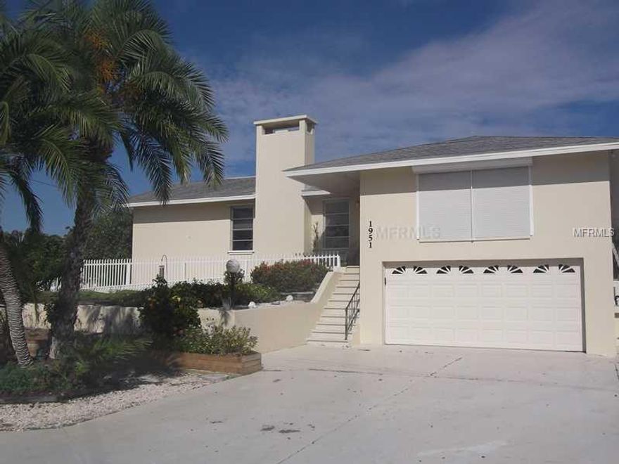 Fantastic Englewood waterfront home has no bridges to Lemon Bay and the Gulf of Mexico. This 3 bedroom/3 bath home offers magnificent sunsets down the waterway from the pool as well as inside activity areas. Sliding doors lead to the elevated pool deck enabling you to enjoy your outdoor living and water views. The dock has water and electric, is 60' long and includes a 20' boat lift for your fishing or water sport activities. The kitchen has crisp bright cabinets and solid surface counter tops, breakfast bar and wet bar, and views of the gas fireplace across the tiled family room. The partially fenced home is elevated and offers a downstairs to the two car garage and additional space that could easily be used as a workshop or for your hobbies. Roll down window and other hurricane protection is provided for the living spaces. This is definitely waterfront living at its best! You have finally found that perfect home for you and your boat. One year warranty core coverage plan for home and pool. A current elevation certificate is available showing base flood plain at 12.0 and the first habitable floor of home at 13.5. Flood insurance is estimated to be $1200 to $1800 per year under the new guidelines.