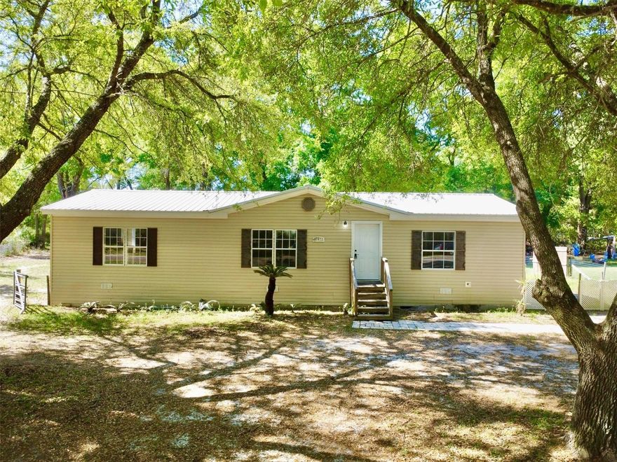 Welcome to your own slice of peaceful North Florida living in beautiful High Springs, FL! Situated on a spacious .60-acre lot, this 3-bedroom, 2-bathroom, 2005 built doublewide mobile home is 1,512 square feet and gives you the option to live with freedom and flexibility. The home has a newer metal roof and hot water heater and the split-bedroom floor plan provides a good sized primary suite with a walk-in closet on one side of the home and two additional bedrooms on the other that give versatility for guests, a home office, or hobbies. The main living area has vaulted ceiling and an open floorplan for the living room, dining area and kitchen to all flow together. Outside is where this property really shines. Sitting on over half an acre, you’ll love the space you have to spread out—whether it’s for entertaining, gardening, or bringing your boat, RV, or other toys. With no HOA, you have the freedom to truly make this property your own. Enjoy the quiet, country-style setting while still being just a short drive (all on paved roads) to downtown High Springs where there are local shops, restaurants, and the famous natural clear water springs- like Ginnie, Blue & Poe, to name a few. And you are only a 30 minute commute to Gainesville- home of the University of Florida, Santa Fe College and a few hospitals, one of which is a VA hospital. If you’ve been searching for a place that you can put in some touches of your own to live your lifestyle all under the price of $200K—this one checks all the boxes! Call for more information and to schedule your private showing today!