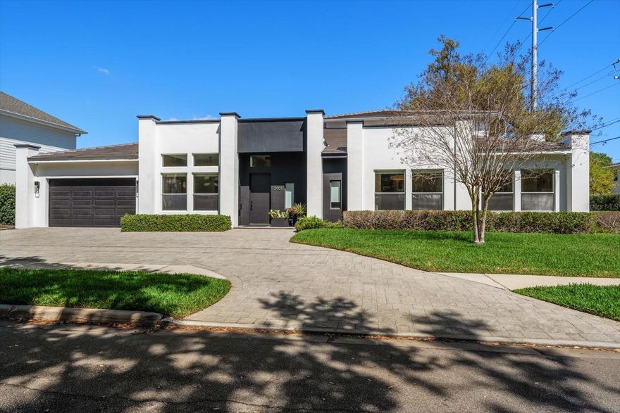 Welcome to this stunning contemporary South Tampa neighborhood, perfectly positioned in one of the area's most desirable neighborhoods with access to top-rated schools( Plant High School) and minutes from the area's best dining, shopping and waterfront amenities. 
This elegant home offers 5 bedrooms, 5.5 bathrooms, and a 2 car garage. This thoughtfully designed floor plan features expansive living spaces filled with natural light, high ceilings, and seamless indoor-outdoor flow. Engineered hardwood floors are consistent through the entire home with the exception of the bathrooms. The chef's kitchen offers a natural gas cooktop, open shelving, wine fridge, new quartz counters and hidden storage cabinets under the island. This kitchen opens up to the main living and dining areas, creating the perfect setting for gatherings. French doors flank each side of the double sided indoor/outdoor gas fireplace. The primary suite situated on the first floor boasts two custom built, walk in closets,large sitting area, Lutron shades and custom made curtain panels. The primary bathroom features oversized double vanities with a third makeup vanity, free standing tub and large walk in shower. Just outside the 2nd and 3rd bedrooms you will find a generous sized office/playroom with hidden study under the stairs. The second level features a spacious game/media room equipped with a wet bar sink, cigar humidor, wine fridge, ice maker and private balcony overlooking the pool. Perfect for entertaining and relaxing. This exquisite home features many upgrades such as Lutron shades on the windows, smart home technology, Cat 5 cable, quartz counters, two A/C units replaced in 2020, high end light fixtures, two tankless gas hot water heaters, electric car home charger, rebuilt hot tub and salt pool resurfaced and tiled in 2025. With its modern design, prime South Tampa location, luxury pool home lifestyle, this property offers the perfect combination of comfort and convenience.