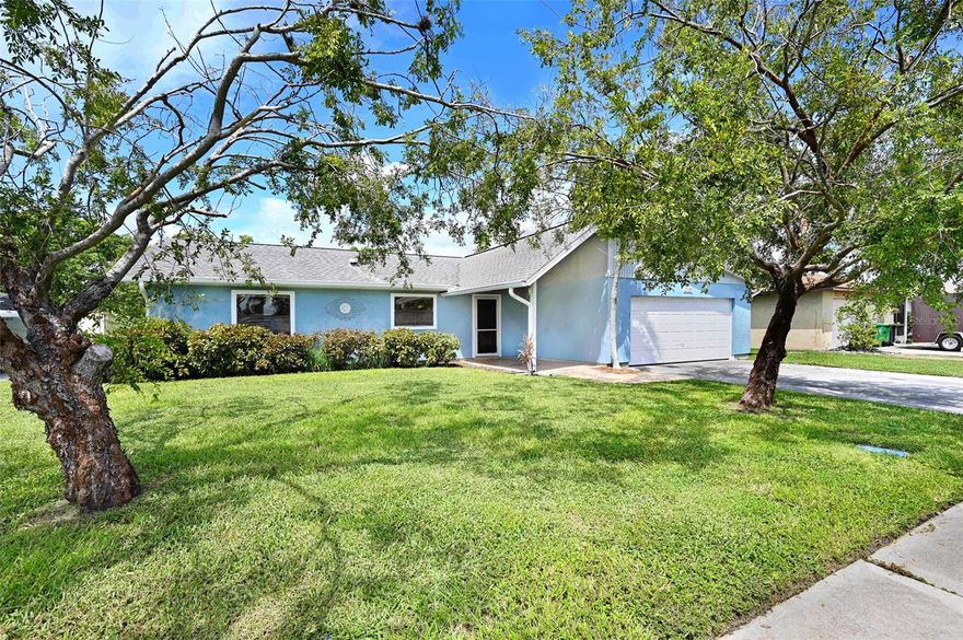 Come see this spacious home! Open layout as you walk in with a great room boasting a corner wood burning fireplace, large dining area and updated kitchen with a breakfast bar! Love the bright kitchen window overlooking the front yard! Split bedroom plan! Primary bedroom has sliders to the backyard! Very large guest bedrooms - one has sliders to the backyard too! Huge Florida room with glass windows under A/C offers a wonderful area for entertaining! Great central location with high end waterfront homes right across the street! Easy to show! See private remarks