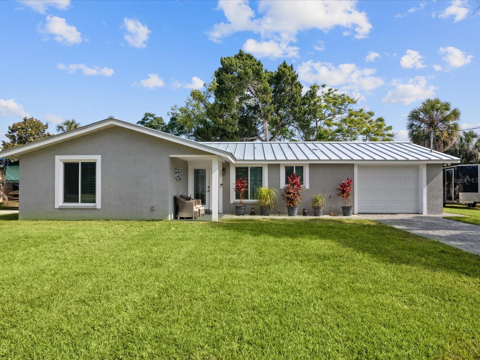 Welcome to your dream Florida home! This charming 2-bedroom, 2-bathroom Florida Ranch style home is located at 5425 Bluepoint Dr in Port Richey, FL, and is waiting for you to call it yours. Imagine sipping coffee on the covered front porch and soaking in the sunshine every morning. You can enjoy kayaking, power boating, and jet skiing right from your own backyard with access to Millers Bayou, Cotee River, and the Gulf of Mexico. The newer seawall with 106’ of water frontage is perfect for your future boat lift or just tie up to the floating dock. You’ll be sure to host many gatherings in the spacious backyard with a lush tree canopy to keep you cool.
The home was renovated in 2021, featuring a metal roof, adding to the durability and longevity of the home. You’ll fall in love with the 10’ island and stainless appliances. The 28-acre oversized lot offers plenty of space for your outdoor activities and relaxation.
This home is not only perfect for your water activities, but it is also located within walking distance to waterfront restaurants and parks, and just a short drive to public beaches. Plus, being only 45 minutes away from Tampa International Airport makes it easy for you to travel to and from your new home. Don’t miss out on the opportunity to make this beautiful waterfront property your forever home.