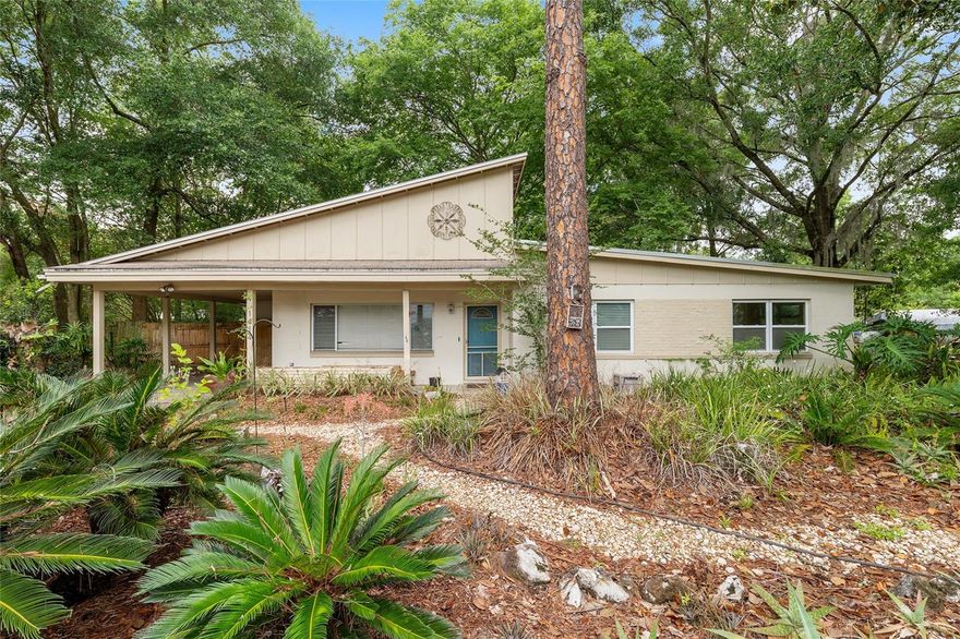 Step into the timeless appeal of this true Mid-Century Modern contemporary home, originally built in 1957 and filled with authentic character and architecture. Featuring 3 bedrooms, 2 baths, and a one-car carport, this residence offers a wonderful blend of vintage details and open living spaces.  Inside, original parquet wood floors flow throughout the home with no carpet anywhere, while both baths showcase original vintage tile that perfectly complements the home’s mid-century style.  The open floor plan creates an inviting atmosphere with a spacious great room, dining area, and an expansive air-conditioned sun room filled with natural light and peaceful views of the backyard. Slate flooring, shelving, and walls of windows make the sun room a standout gathering space. The kitchen features stainless steel appliances including a smooth-top range, newer Samsung dishwasher, and slate floors.  The large primary suite includes an en-suite bath, while two generously sized guest bedrooms provide flexibility or home office space. Extensive built-in storage lines the hallway, and the spacious laundry area located off the breezeway behind the carport includes washer, dryer, and additional storage space.  Outside, the xeriscape landscaping creates a unique low-maintenance setting both front and back. The fenced backyard is designed with two distinct outdoor living areas, two ponds, and even a chicken coop, creating a private retreat with endless possibilities for gardening, entertaining, or simply enjoying the outdoors.  Major system improvements completed in 2021 include updated wiring and air conditioning.  The home has also been re-plumbed, offering an excellent foundation for the next owner to further personalize the property.  Rich in personality, architectural integrity, and opportunity, this special property offers the chance to own an authentic mid-century home with several important updates already in place and room to make it truly your own.