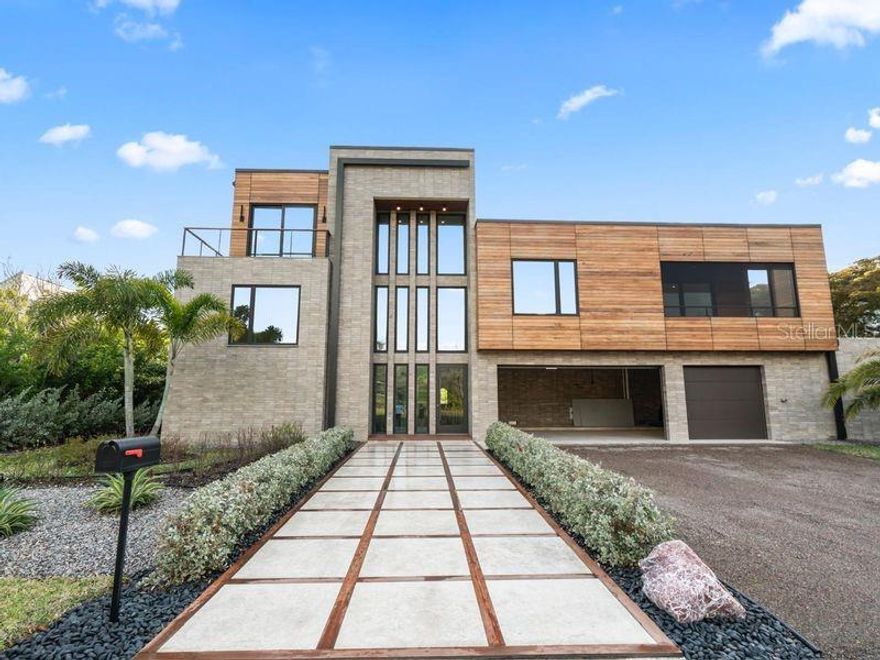 A contemporary masterpiece awaits Your going to love this house !, constructed in 2024 and completed in December of 2025 this newly built residence blends contemporary architecture with uncompromising craftsmanship. The craftsmanship, and finishing touches puts this property in a class by itself when making your buying comparisons.  Worth repeating….Your going to love this house!
Step into more than 3,800 square feet of modern design perfection ideally located in one of Longboat Keys most coveted neighborhoods. Just minutes on foot brings you to pristine beach access or a tee time at the prestigious Longboat Keys club. 
Seamless indoor- Outdoor living, a stunning floor to ceiling glass wall sets the tone from the moment you walk in revealing a private courtyard that feels like your own luxury resort, complete with an elegant pool, a relaxing spa, and a fully equipped outdoor kitchen and dining area.
This harmonious flow creates an exceptional living experience where the outdoors becomes an extension of the home .
Refined interiors inside , warm oak wood flooring runs throughout the home beautifully paired with stone accents , sleek cabinetry , and high end finishes.
The chef designed kitchen is crafted for culinary excellence and features quartzite countertops prized for their durability, beauty, and unmistakably high end character.
The primary suite is a serene retreat with glass walls overlooking the courtyard , a soaking tub , a separate shower, and generous storage.
Spaces designed for comfort the home offers five bedrooms including 
An in law suite with a kitchenette, private laundry, spacious bedroom, and walk in shower.
An additional bedroom on the main level with its own private balcony .
Upstairs two guest suites connected by a bright relaxation area with courtyard views through the floor to ceiling glass.
Striking modern architecture, the exterior showcases clean contemporary lines enhanced by rare hand selected stone and rich custom woodwork. 
Come visit this spectacular offering.
..