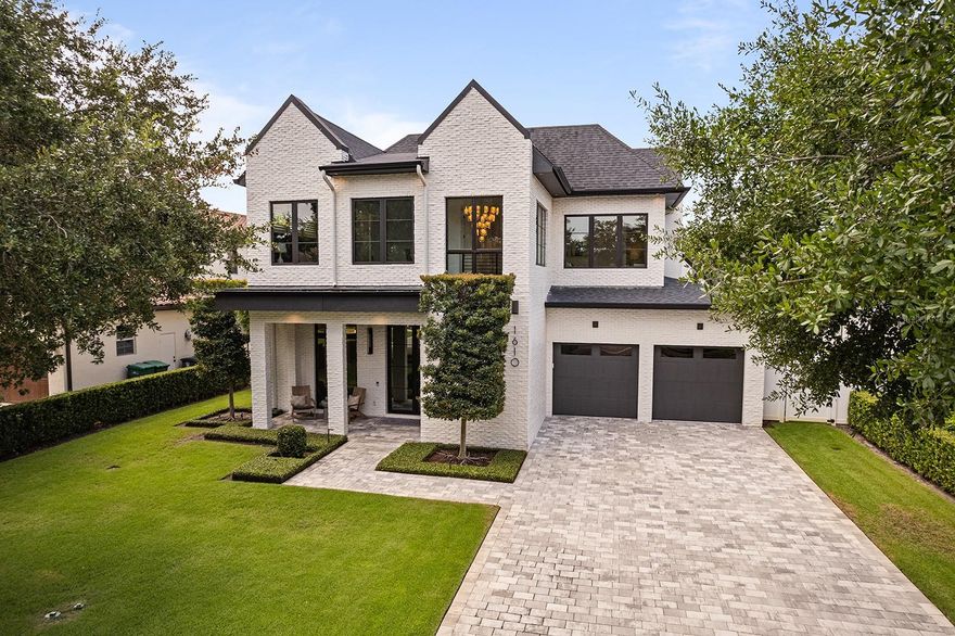 This stunning modern farmhouse residence, custom-built in 2021 with meticulous attention to detail offers a bright open living design, luxurious finishes, and an ideal floor plan for everyday living and grand-scale entertaining. This home includes five en-suite bedrooms (owner’s suite and potential guest suite on first level) and three bedrooms, plus lounge/flex area upstairs… or a fourth bedroom, office plus lounge/flex area and five full baths plus 2 1/2 baths. The entire property has been maintained in better than new condition featuring gorgeous light wood flooring that transcends the entire home with elegant herringbone design throughout the entry foyer. The open-concept layout is flooded with natural light thanks to walls of sliding glass doors, including a disappearing wall that seamlessly connects the indoor living spaces with the incredible outdoor transitional lanai that is really cool to enjoy outdoor living and has its mini-split air conditioning system. The chef’s kitchen is a showstopper, featuring top-of-the-line appliances, a large island with seating, integrated refrigeration, wine refrigerator and a hidden butler’s pantry with an additional refrigerator—all open to the spacious dining and living areas. The living room showcases floor-to-ceiling windows, a striking fireplace with built-ins, and tranquil views of the beautifully landscaped yard and pool. The private first-floor primary suite features direct access to the backyard and a spa-like bath with a soaking tub and oversized glass shower. A second first-floor bedroom suite, used as an office, provides versatility for guests or multi-generational living. Upstairs, there is a spacious lounge area and three additional bedrooms with en suites, all featuring walk-in closets. The outdoor lanai offers a summer kitchen, gas fireplace and remote-controlled screens under soaring wood ceilings, creating a year-round gathering space. Complemented by a resort-style pool and heated spa surrounded by lush tropical landscaping and manicured bamboo for total privacy. Additional highlights include a drop off/mudroom zone off the two-car garage, a generous laundry room, and an ideal location on a charming brick street just minutes from Park Avenue’s shops and restaurants. Zoned for top-rated public schools and near elite private schools, with easy access to Phelps Park, YMCA, ICC, WPRC and Park Avenue—this exceptional home checks every box!