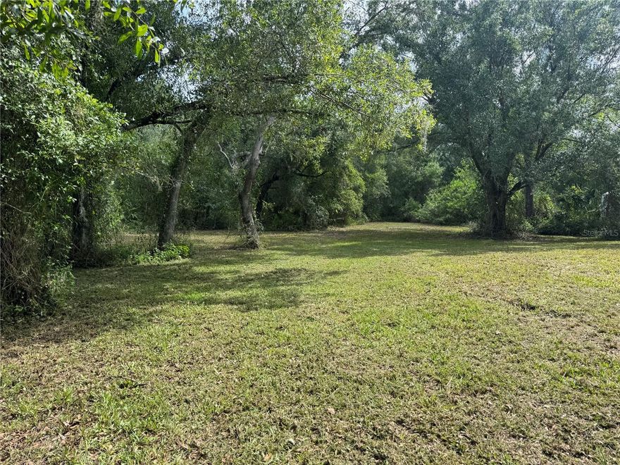 This nearly half-acre property, made up of two beautifully maintained lots, offers a rare opportunity to build not just one, but possibly two homes in a peaceful, private setting. Freshly mowed and thoughtfully cleared, the land is dotted with gorgeous mature trees and native foliage that provide a quiet, tucked-away feel—while still being just minutes from local schools, shopping, restaurants, I-75, and grocery stores. A driveway is already in place, and there’s an existing well and septic system on site (conditions unknown), giving you a head start on development. Zoned for single-family, modular, or manufactured homes, this property offers flexibility, space, and convenience all in one. Buyers are encouraged to verify all building and zoning details with DeSoto County to ensure it’s the perfect fit for their plans.
