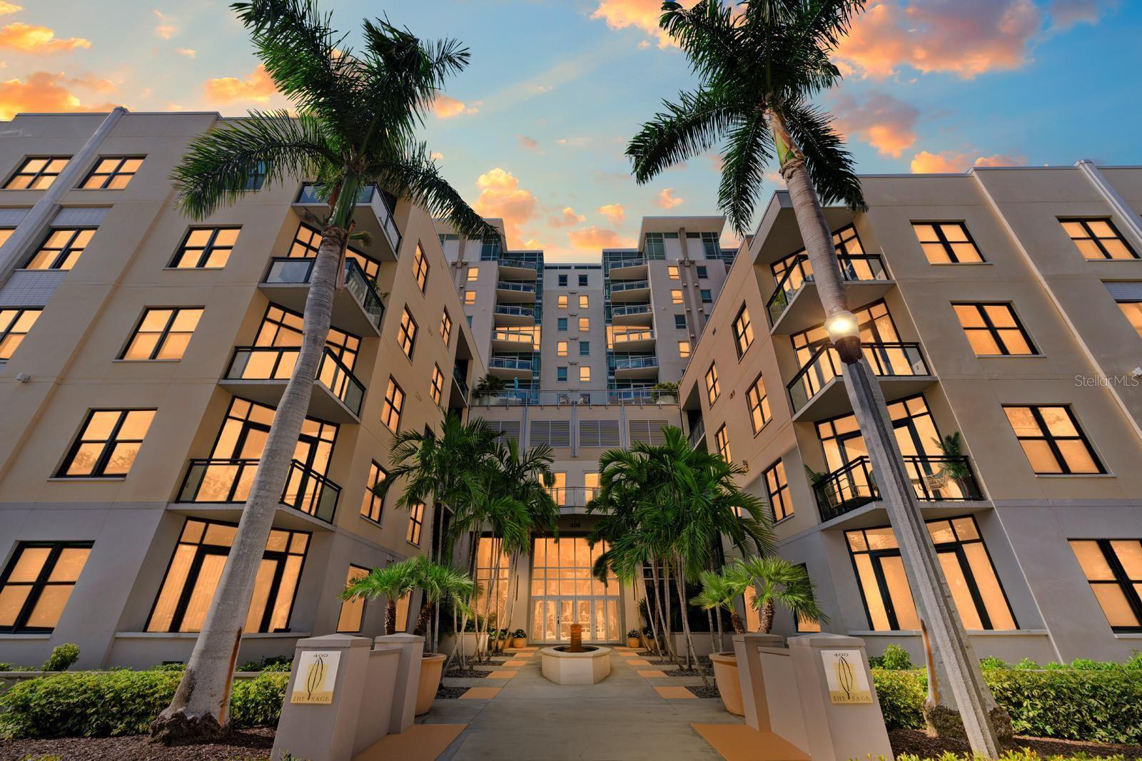 One or more photo(s) has been virtually staged. Welcome to The Sage—designed with your security, convenience, and privacy in mind, right in the heart of vibrant Downtown St. Petersburg. This highly sought-after 10th-floor residence offers UNBEATABLE VIEWS with 2 spacious bedrooms and 2 full bathrooms along with 2 covered, secured parking spots and secure building entry for peace of mind.
Step inside and be greeted by ENGINEERED WOOD floors throughout the main living spaces, complemented by brand-new carpet in both bedrooms. The split floor plan ensures privacy, while 10-FOOT CEILINGS and large WINDOWS fill the home with NATURAL light. The modern kitchen is a chef’s delight with custom contemporary cabinets, GRANITE countertops, and STAINLESS-STEEL appliances—including a newer microwave and dishwasher. An LG washer and dryer are conveniently located in-unit, and the space is topped off with new ceiling fans and fixtures for a fresh, modern feel.
The master suite features a WALK-IN closet and a SPA-LIKE bath, while the second bedroom is perfect for guests or a home office.
Major updates include a brand-new TRANE HVAC (2024) with a smart thermostat, plus a water heater just 6 years old—so you can move in with confidence.
Relax on your PRIVATE BALCONY and take in serene city views or enjoy The Sage’s resort-style amenities: a heated pool, social room, outdoor kitchen, fitness center, and an on-site car wash area. Enjoy the best of city life with restaurants, museums, galleries, markets, and waterfront parks just steps away. Easy access to I-275 puts you minutes from Tampa, the airport, St. Pete Beach, and our world-famous Gulf beaches.
Move-in ready and waiting for you—come see why life is better at The Sage!