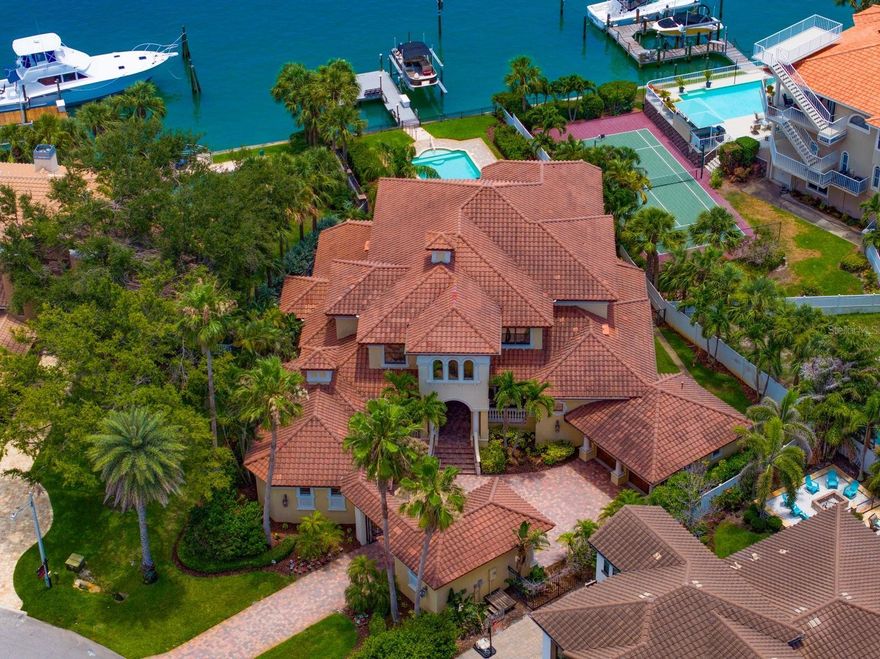 Elegant Italian Style Villa home with paved courtyard enclosed by decorative wrought iron gate. Welcome to 841 Ponce de Leon Drive - a Waterfront Estate in Tierra Verde where elegance meets ease! This architecturally stunning home is fully furnished and move-in ready with 5 bedrooms and 7 full baths. It blends high-end design with thoughtful functionality for the discerning professional or family seeking an elevated coastal lifestyle. Positioned along the Grand Canal, this home is only minutes away from waterfront restaurants, marine services and the Gulf.
 On the main level, towering ceilings create an open airy ambiance. The gourmet kitchen features granite counter tops, high-end appliances including a 6 burner gas stove and electric warming oven and seamlessly flows into the inviting living and dining space.
 Two first floor oversized suites, one with a private exterior entrance, both have ensuite baths. The Master suite has an expansive walk-in closet with a built-in island, custom 2 tiered hanging space as well as an extra large shower with multiple shower heads and an oversized whirl-pool tub. The library/office, bonus room and 4 full baths - including a pool bath - maximize flexibility and comfort.
 Ascend the winding staircase to a reading nook, expansive game room complete with kitchenette, full size pool table, poker/game table and expansive water-front views from the 2nd level patio. Three more guest bedrooms, 2 with ensuite baths and 1 with a guest bath complete this upper floor.
 Outdoors, the heated salt water pool and hot tub with a new pool heater intalled in March of 2026, custom built in propane grill, and retractable patio shade canopy promise resort-style relaxation. A private dock with a 12,000 lb. lift and room for additional watercraft make boating a daily affair. Tri-toon boat negotiable.
 Other amenities include a 3+ car garage  with extra refrigerator, an upright freezer, 2 hot water heaters with one just being installed in September, 2025, and 3 zoned air conditioners. 
 Every corner of this home is crafted for comfort, style and seamless indoor-outdoor living. 
 Make an appointment for a private showing today.