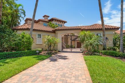 Elegant Italian Style Villa home with paved courtyard enclosed by decorative wrought iron gate. Welcome to 841 Ponce de Leon Drive - a Waterfront Estate in Tierra Verde where elegance meets ease! This architecturally stunning home is fully furnished and move-in ready with 5 bedrooms and 7 full baths. It blends high-end design with thoughtful functionality for the discerning professional or family seeking an elevated coastal lifestyle. Positioned along the Grand Canal, this home is only minutes away from waterfront restaurants, marine services and the Gulf.
On the main level, towering ceilings create an open airy ambiance. The gourmet kitchen features granite counter tops, high-end appliances including a 6 burner gas stove and electric warming oven and seamlessly flows into the inviting living and dining space.
Two first floor oversized suites, one with a private exterior entrance, both have ensuite baths. The Master suite has an expansive walk-in closet with a built-in island, custom 2 tiered hanging space as well as an extra large shower with multiple shower heads and an oversized whirl-pool tub. The library/office, bonus room and 4 full baths - including a pool bath - maximize flexibility and comfort.
Ascend the winding staircase to a reading nook, expansive game room complete with kitchenette, full size pool table, poker/game table and expansive water-front views from the 2nd level patio. Three more guest bedrooms, 2 with ensuite baths and 1 with a guest bath complete this upper floor.
Outdoors, the heated pool and hot tub, custom built in propane grill, and retractable patio shade canopy promise resort-style relaxation. A private dock with a 12,000 lb. lift and room for additional watercraft make boating a daily affair. Tri-toon boat negotiable.
Other amenities include a 3+ car garage with extra refrigerator, an upright freezer, 2 hot water heaters and 3 zoned air conditioners.
Every corner of this home is crafted for comfort, style and seamless indoor-outdoor living.
Make an appointment for a private showing today.