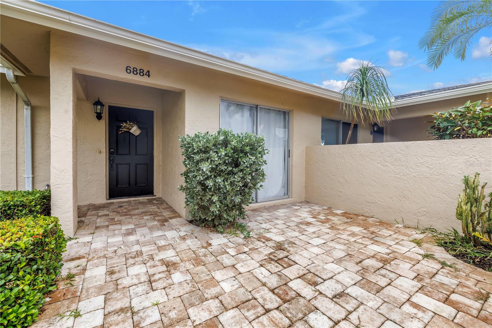 Welcome to 6884 W Country Club Ln—a beautifully updated residence nestled in the coveted Palm-Aire Country Club community. This 2-bedroom, 2-bathroom home offers over 1,100 square feet of comfortable living space, combining modern upgrades with timeless Florida charm. Inside, you’ll find a bright, open floor plan and large windows that flood the space with natural light. The updated kitchen features stainless steel appliances and ample cabinetry—ideal for the home chef. The primary suite includes a walk-in closet and an en-suite bathroom. An additional suite with an en-suite bathroom offers flexibility for guests or a home office. The enclosed lanai is perfect for entertaining or quiet mornings with a cup of coffee. Two private patios overlook an abundance of green space. Situated in a desirable location within the Palm-Aire community, this home is just steps from the golf course and amenities, which include a community pool and tennis courts. Located minutes from University Town Center, Sarasota-Bradenton International Airport, downtown Sarasota, and Sarasota’s world-renowned Gulf beaches, this move-in ready home is a rare opportunity in an excellent location.