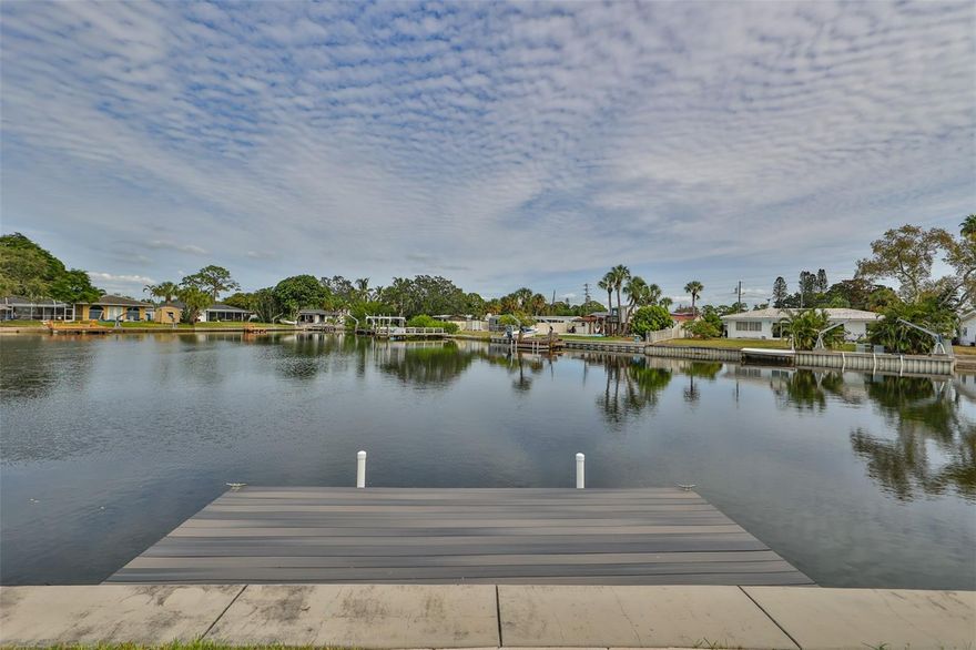 Experience elevated waterfront living at 4713 Dover Street NE in prestigious Waterway Estates. This beautifully updated 3 bed / 3 bath home plus expansive sunroom showcases panoramic water views through all-new oversized windows, with a brand-new roof, fresh interior and exterior paint, and tastefully renovated bathrooms throughout. The master suite offers a stunning newly upgraded bathroom with a private walk-out to the water. A bright, open layout flows into the sunroom, where walls of windows frame sweeping vistas and invite the outdoors in. Outside, a private dock with small lift makes boating effortless, the canal takes you straight to the open Gulf on one side and the pristine Weedon Island Preserve on the other. Native landscaping creates a lush sanctuary that attracts butterflies and pollinators, while the elevated lot provides rare peace of mind compared to neighboring waterfronts. All this, just minutes from vibrant downtown St. Pete with world-class museums, theaters, fine dining, and the Pier, plus convenient access to Whole Foods, Trader Joe’s, Publix, Fresh Market, and Rollin’ Oats. A move-in ready retreat that blends modern luxury, natural beauty, and the best of St. Petersburg living, and for a little more, it is also available fully furnished.